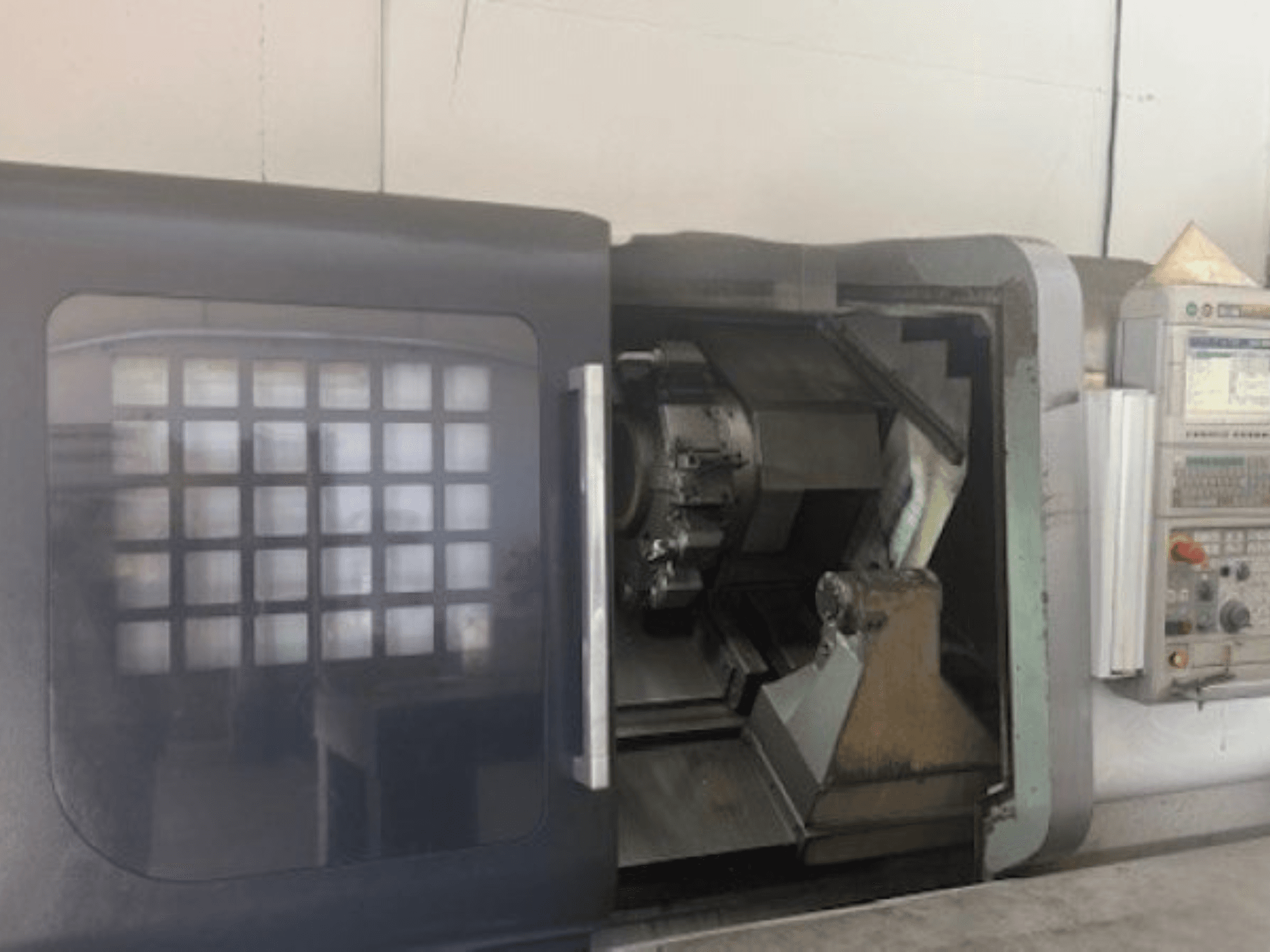 MORI SEIKI NLX 2500M horizontal turning machine, front view showing tool holder, control panel, and interior mechanism.