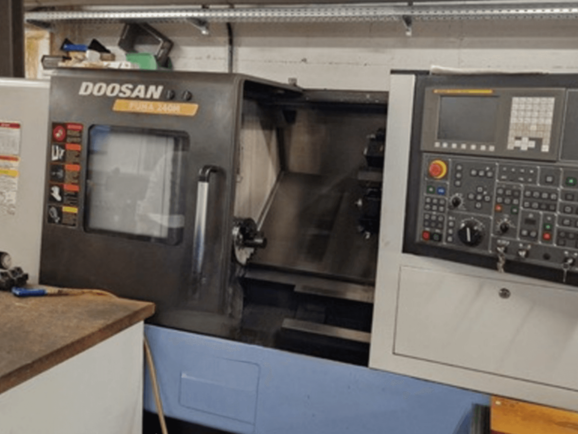 Front view of DOOSAN Puma 240MB horizontal turning machine showing control panel and operational functions.