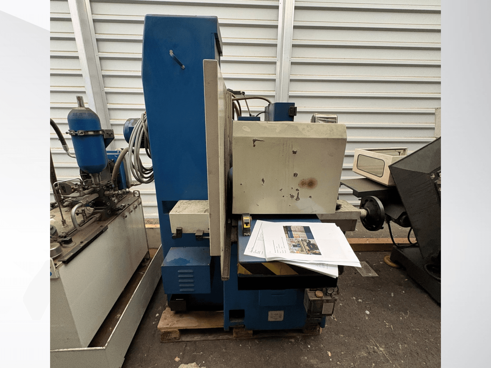 Surface Grinding Machine by KNUTH, model HFS 30638 C, shown from the side with control panel and paper documents on the table.