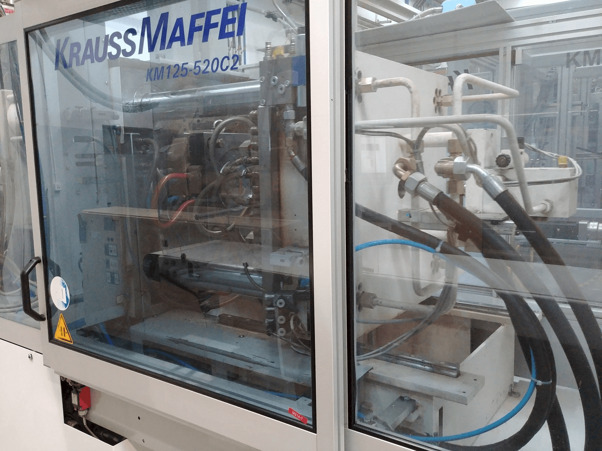 Left view of Krauss Maffei KM 125-520 C2 machine