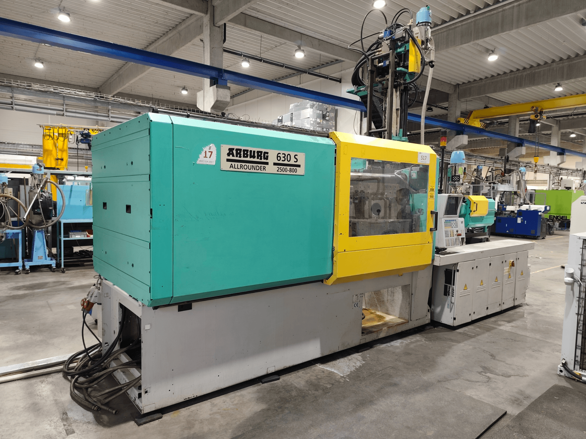 Arburg Allrounder 630S-2500-800/350 hydraulic injection moulding machine, side view, with colorful exterior and control panel visible.