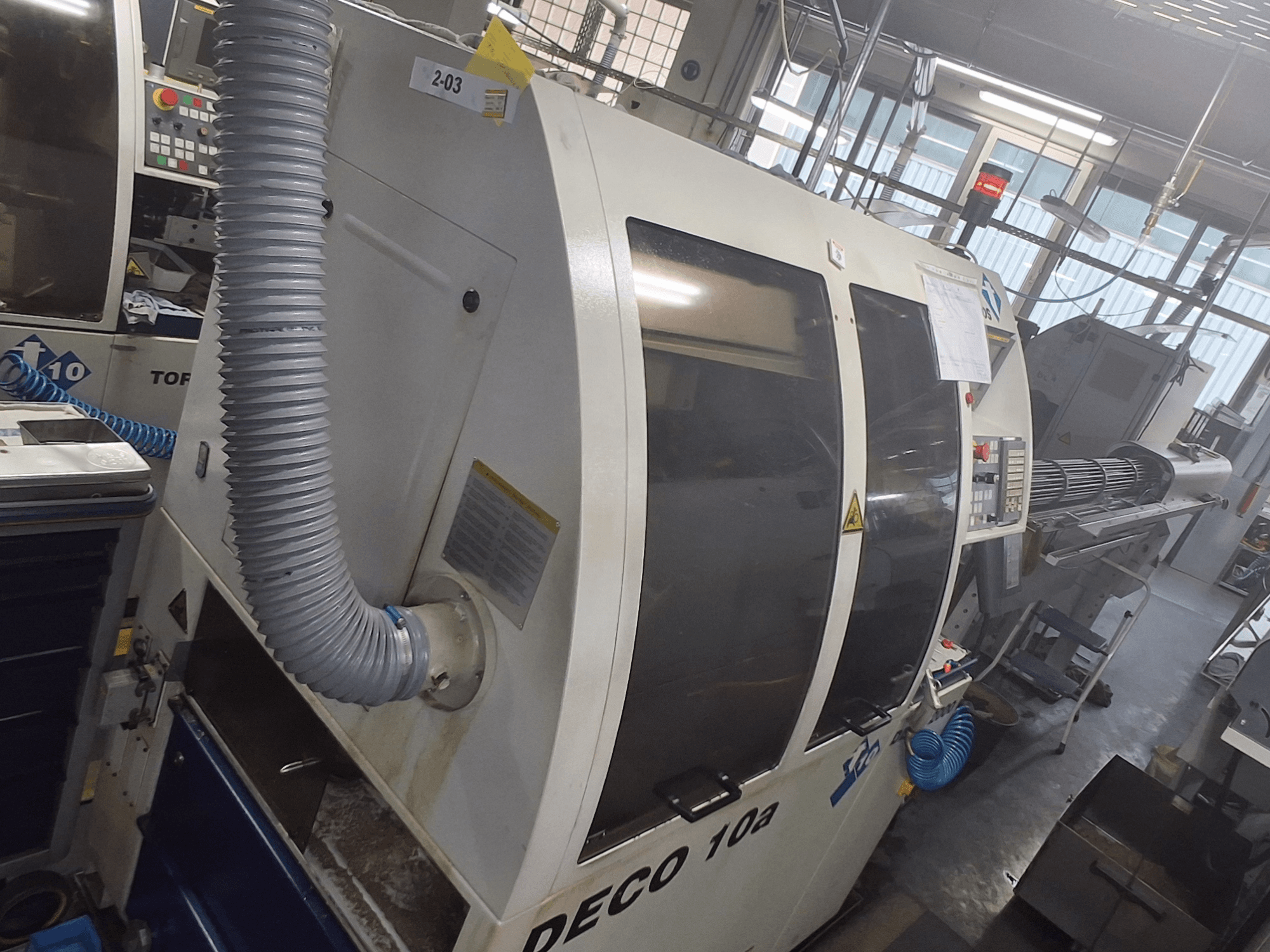 DECO 10a machine in a front view; features a large control panel, ducting, and operational stickers visible.
