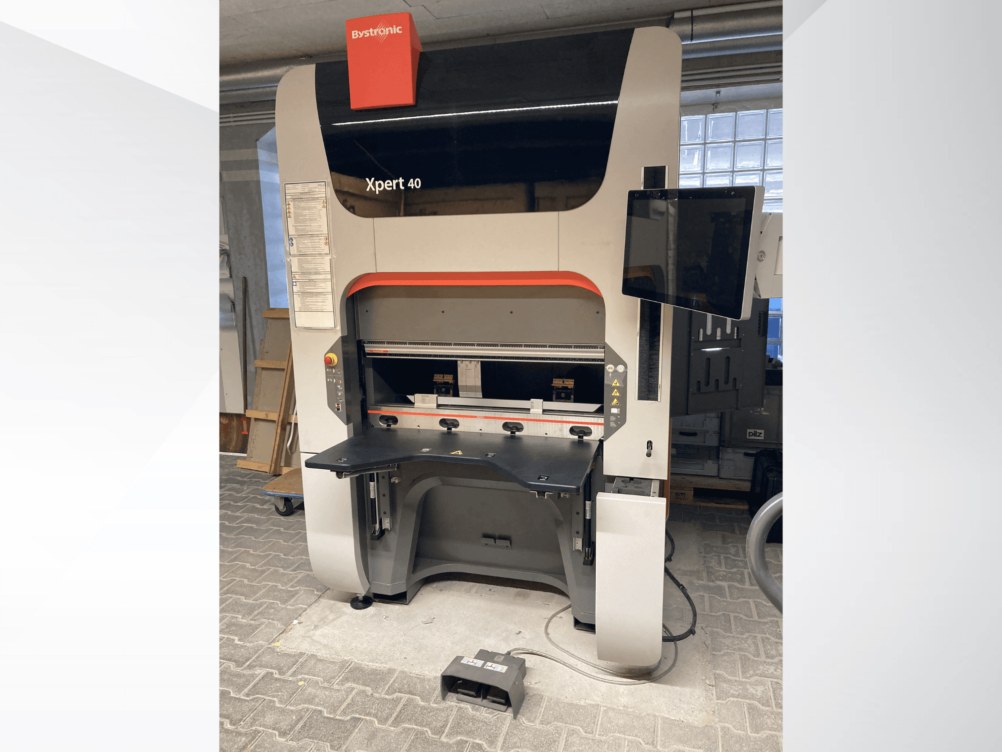 Bystronic Xpert 40/1030 press brake in front view, showcasing control panel, work surface, and attached monitor.