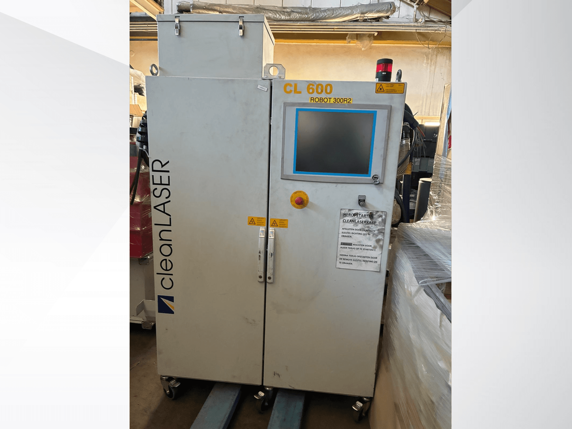 CLEAN LASER CL 600 automation system in front view with LCD display, warning labels, and control buttons on the door.
