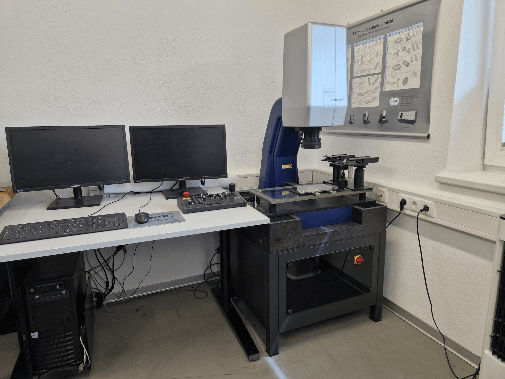 Werth Scopecheck 300S CMM in a lab setup; includes a measurement table, dual monitors, and a control panel.