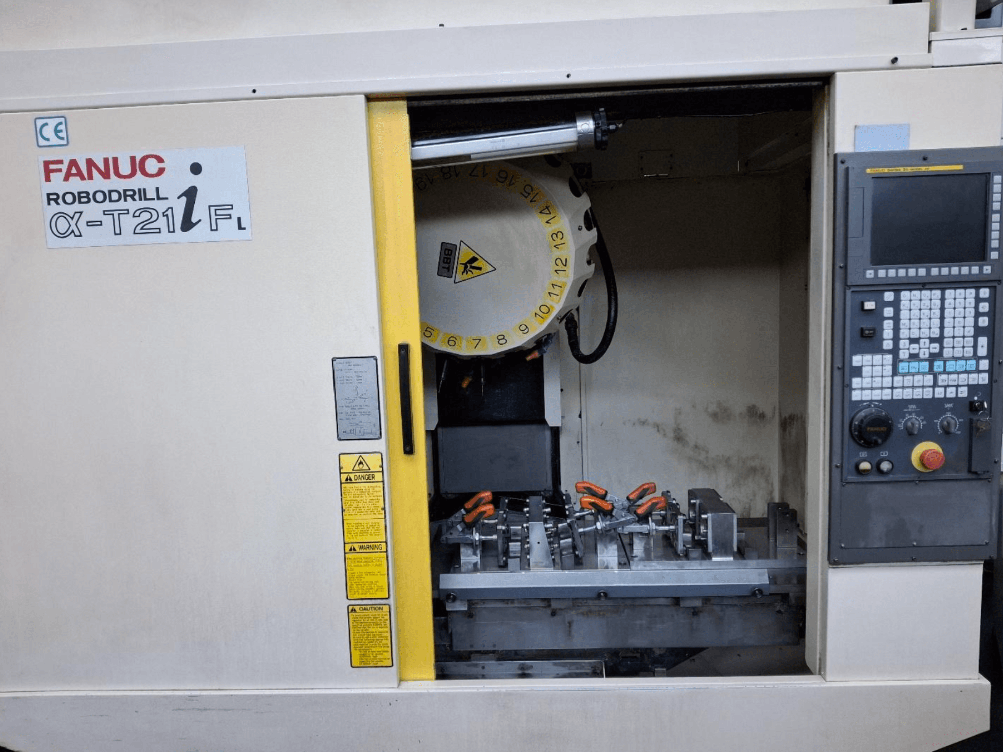 FANUC ROBODRILL α-T21iFL vertical machining center front view, showing tools and controls inside the machine cabinet.