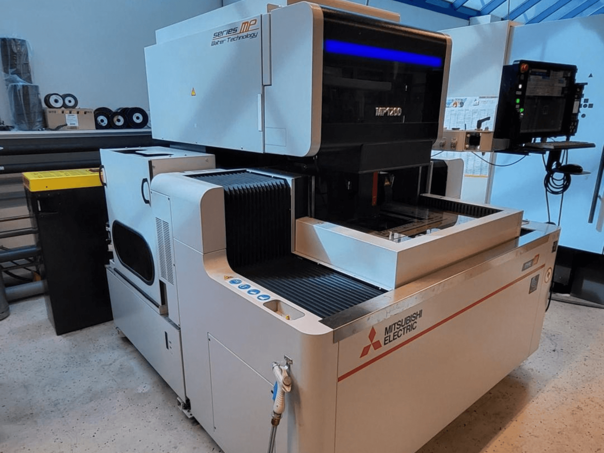 Mitsubishi MP1200 Wire EDM machine, front view, featuring control panel, high-tech details, and sleek design.
