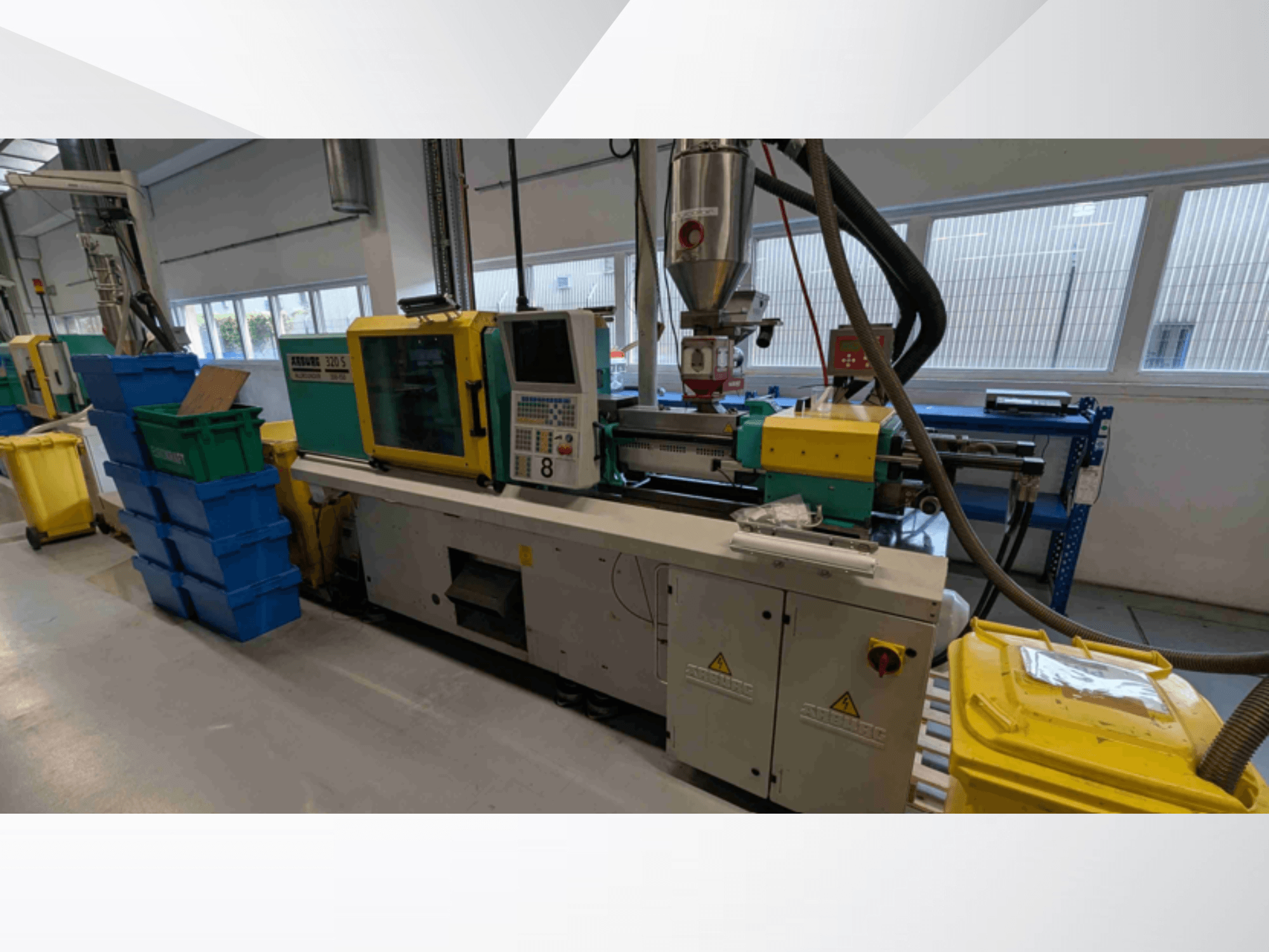 Hydraulic injection moulding machine Arburg 320 S 350-150, front view, showing controls, extruder, and colored bins.