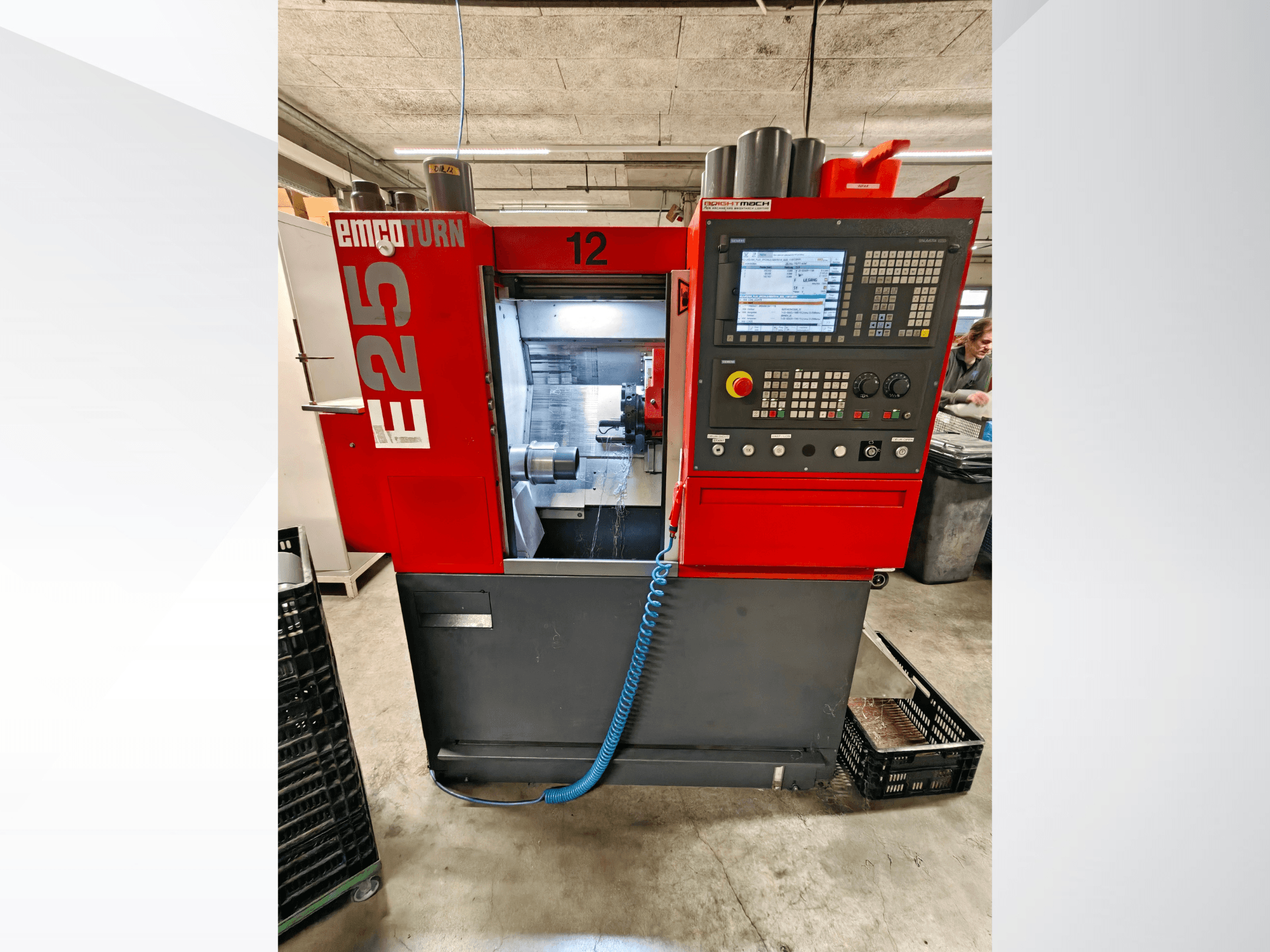 Front view of EMCO E25 horizontal turning machine with a digital control panel and workspace, showcasing operational details.