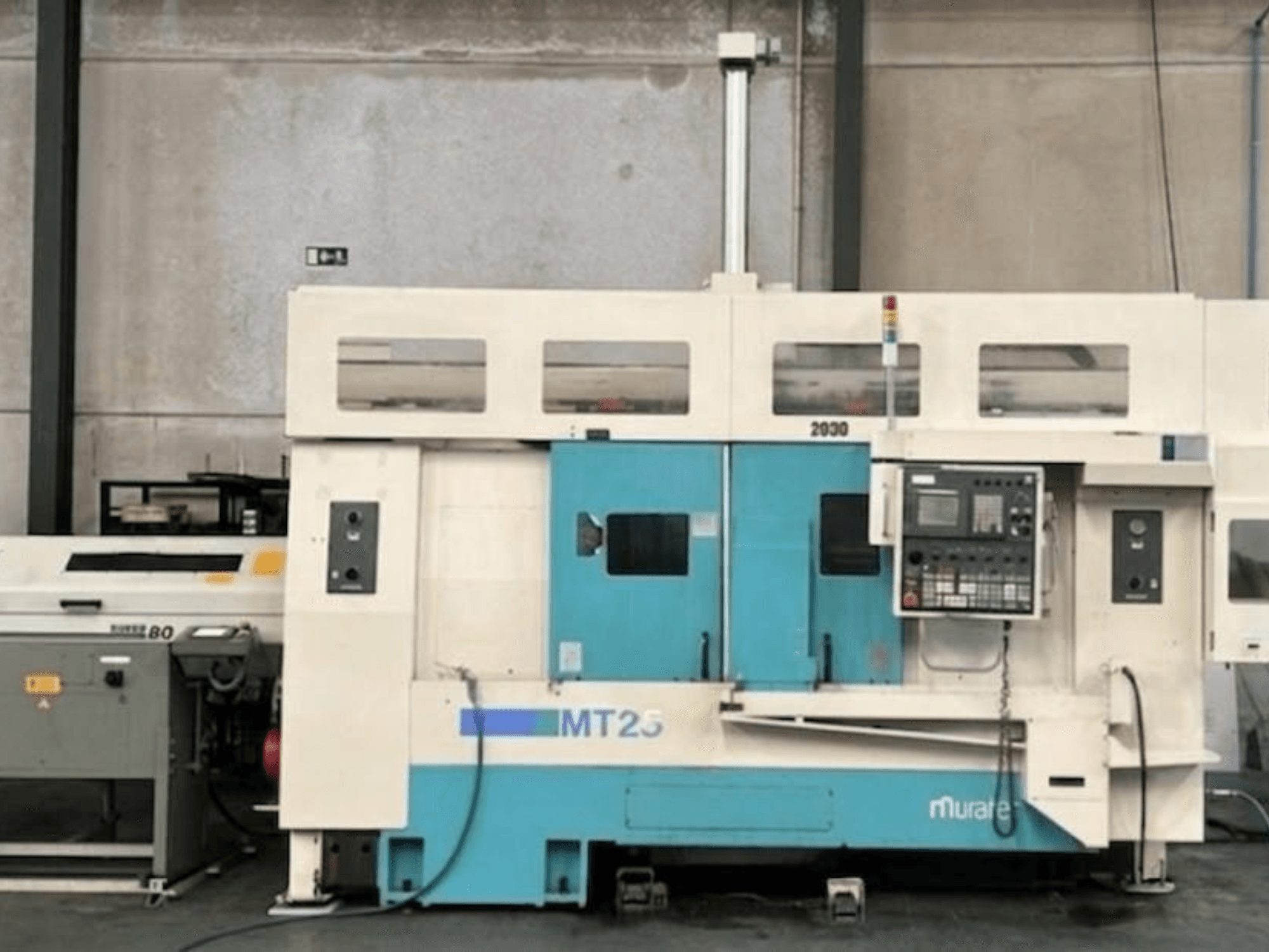 Muratec MT 25 MY turn-mill centre in side view, featuring control panel and blue/white exterior.