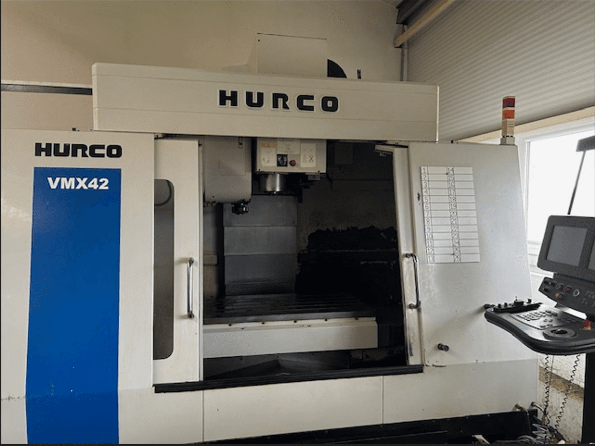 Hurco VMX42 CNC milling machine, front view, features control panel and open workspace for machining operations.