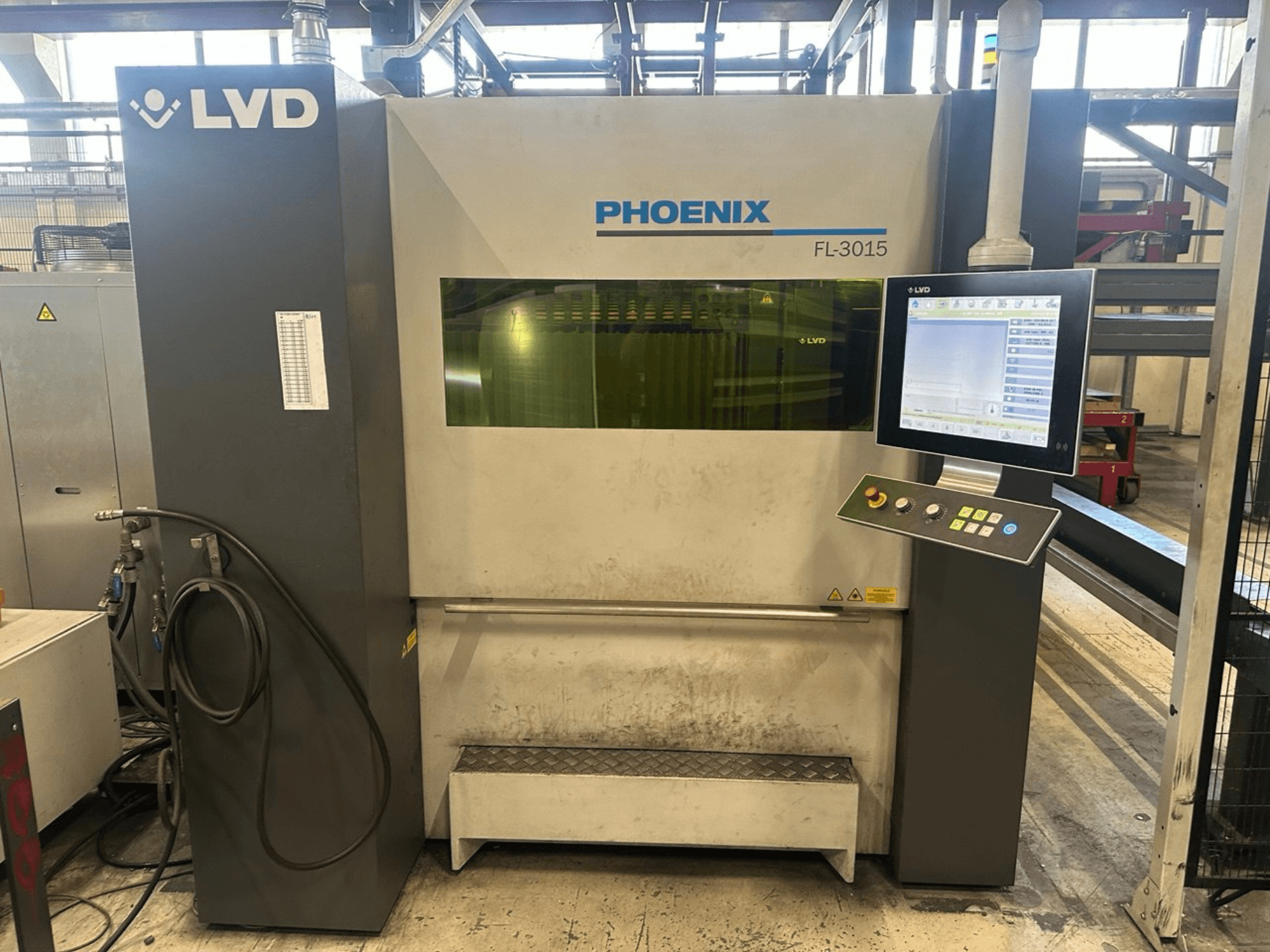 LVD Phoenix FL-3015 laser cutting machine, front view, features a digital control panel and visible tubing.