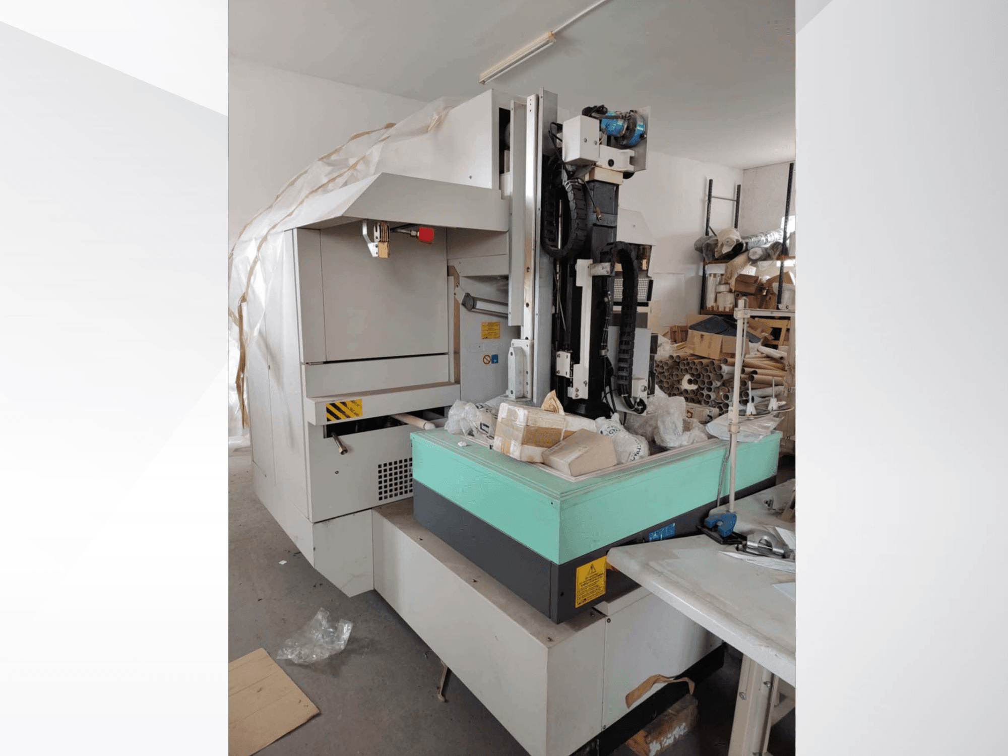 AGIE AGIETRON INTEGRAL 2 die-sinking EDM machine in side view, featuring a green work table and various tools.