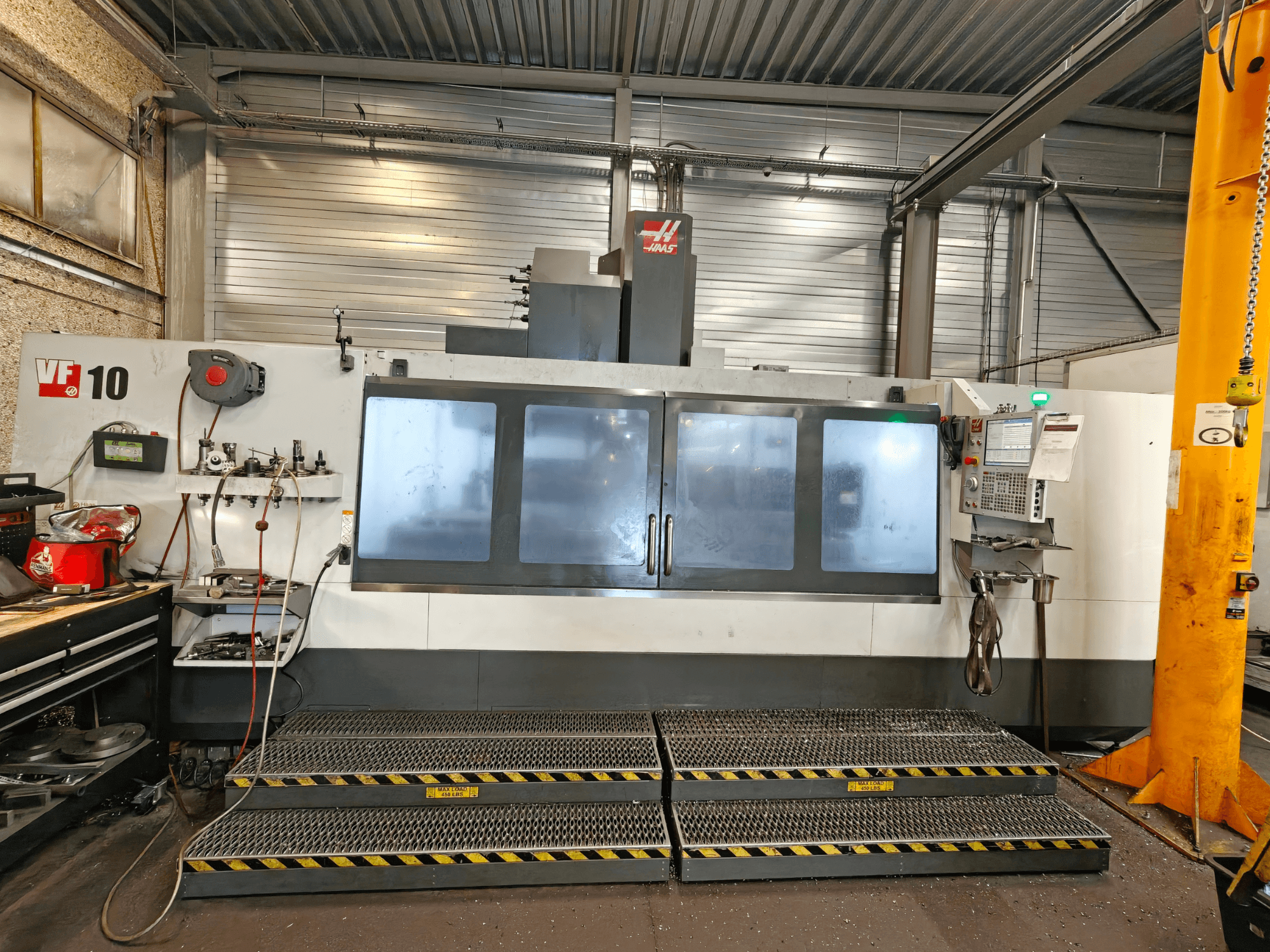 HAAS VF-10/50 vertical machining center, front view, featuring operator controls and large viewing windows.