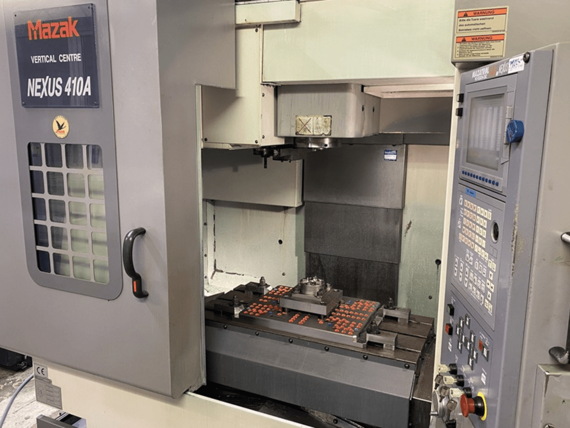 Mazak VCN410 Vertical Machining Centre, front view showing control panel and machine interior with workpiece mounted.