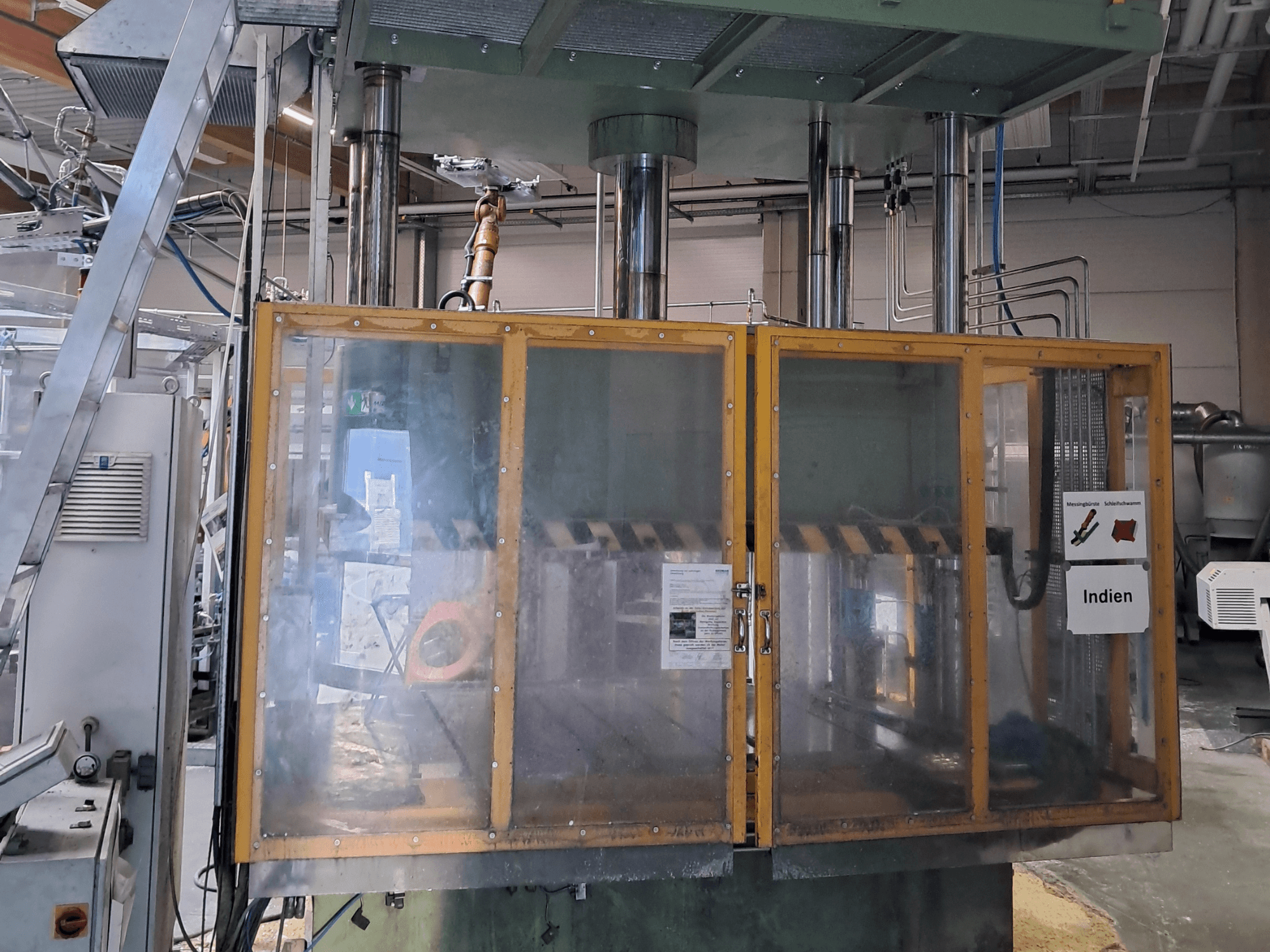 Metal press HS 4 160-K3 by Other, front view showcasing safety glass enclosure and operational controls in an industrial setting.