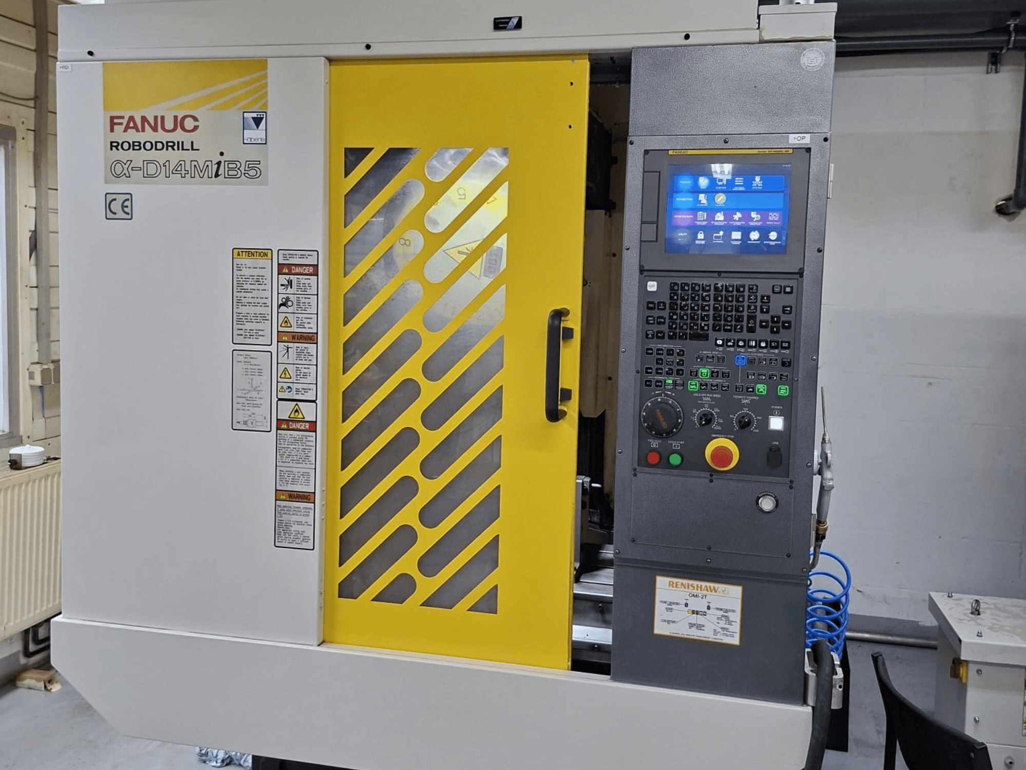 FANUC ROBODRILL α-D14MiB5 vertical machining center, front view showing control panel and safety features with yellow accents.