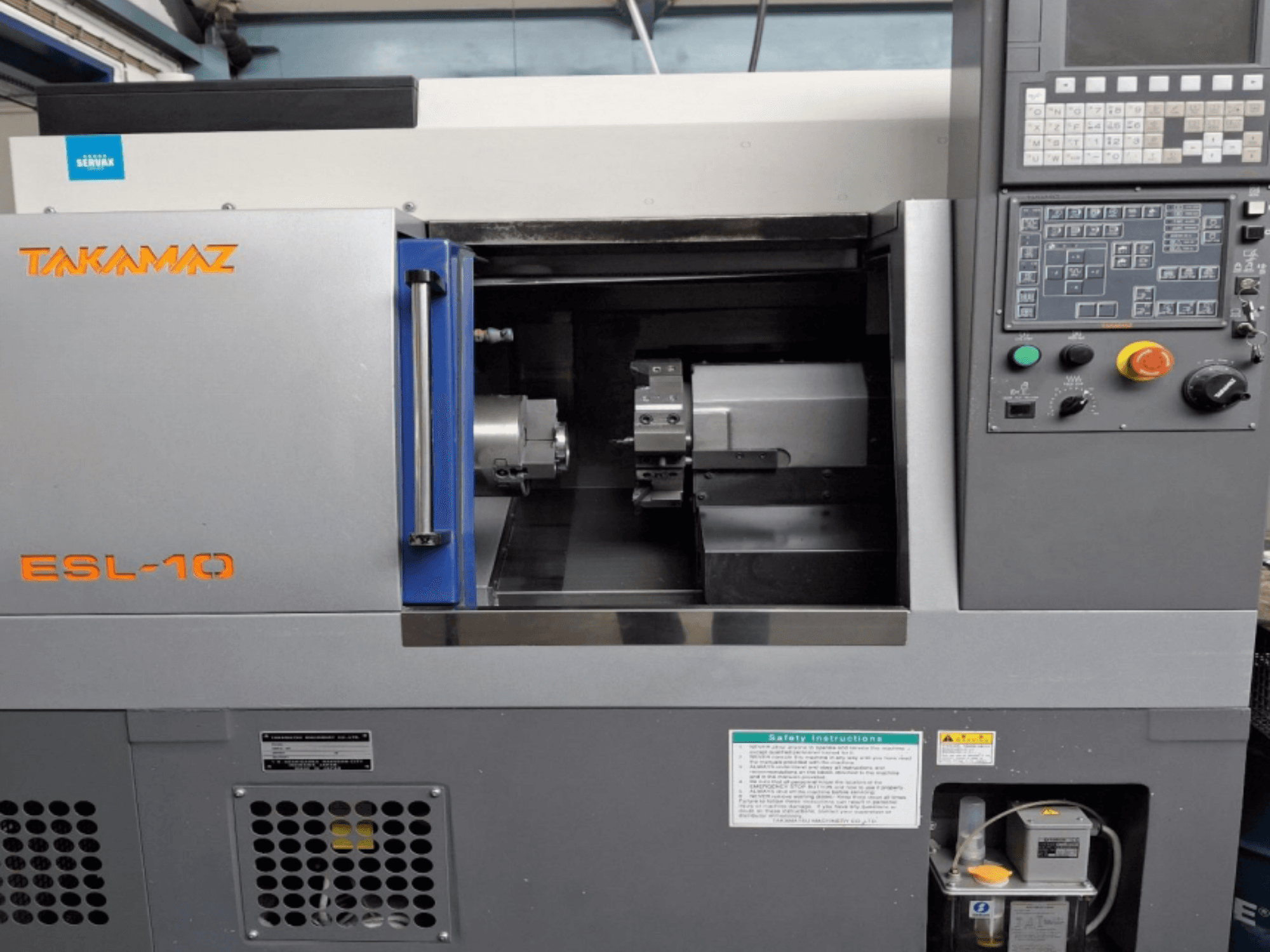 Front view of Takamaz ESL 10 horizontal turning machine, showcasing control panel, spindle, and operational interface.