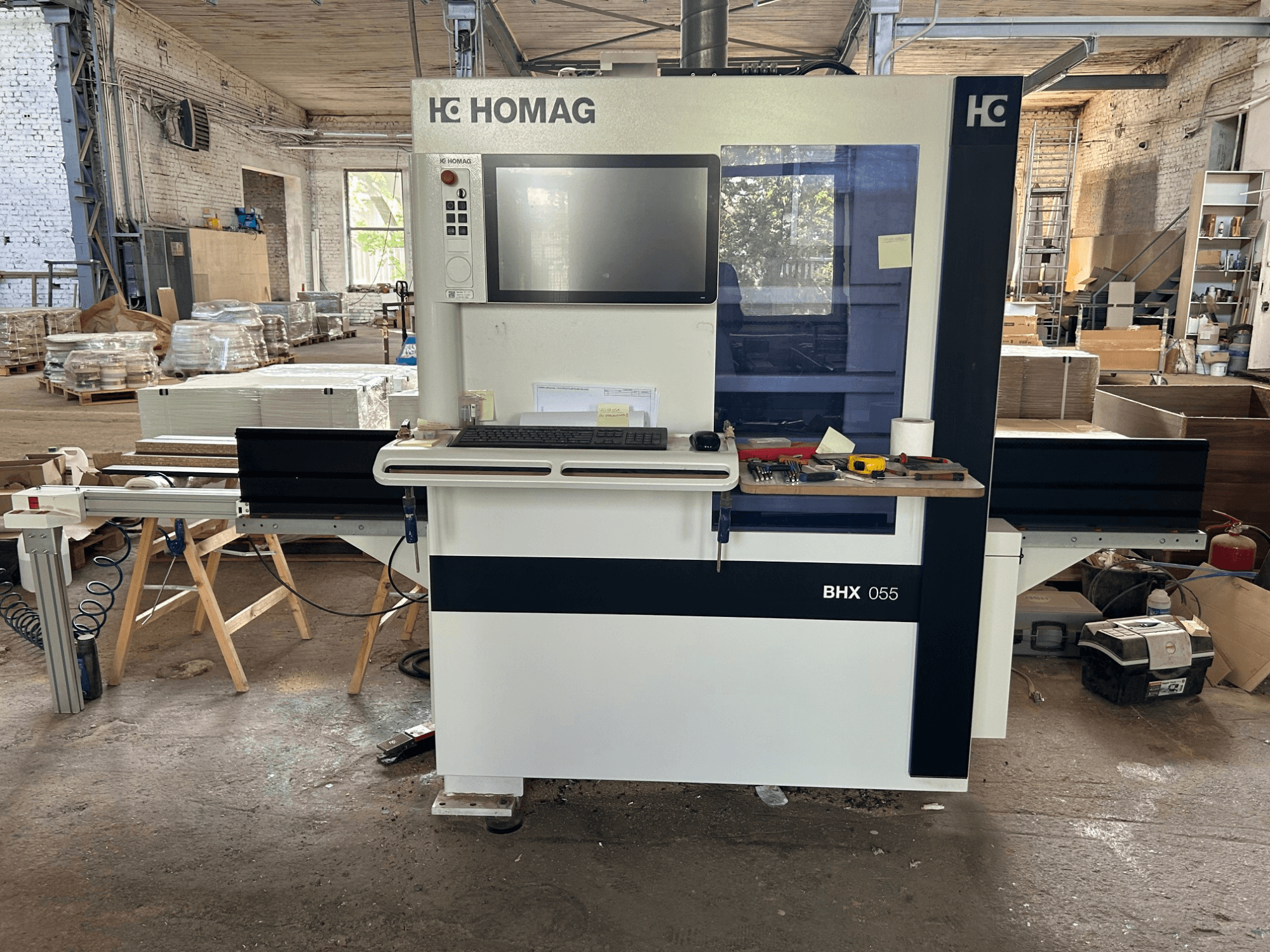 HOMAG WEEKE OPTIMAT BHX 055 CNC Processing Center, front view, showcasing control panel and workspace with tools.