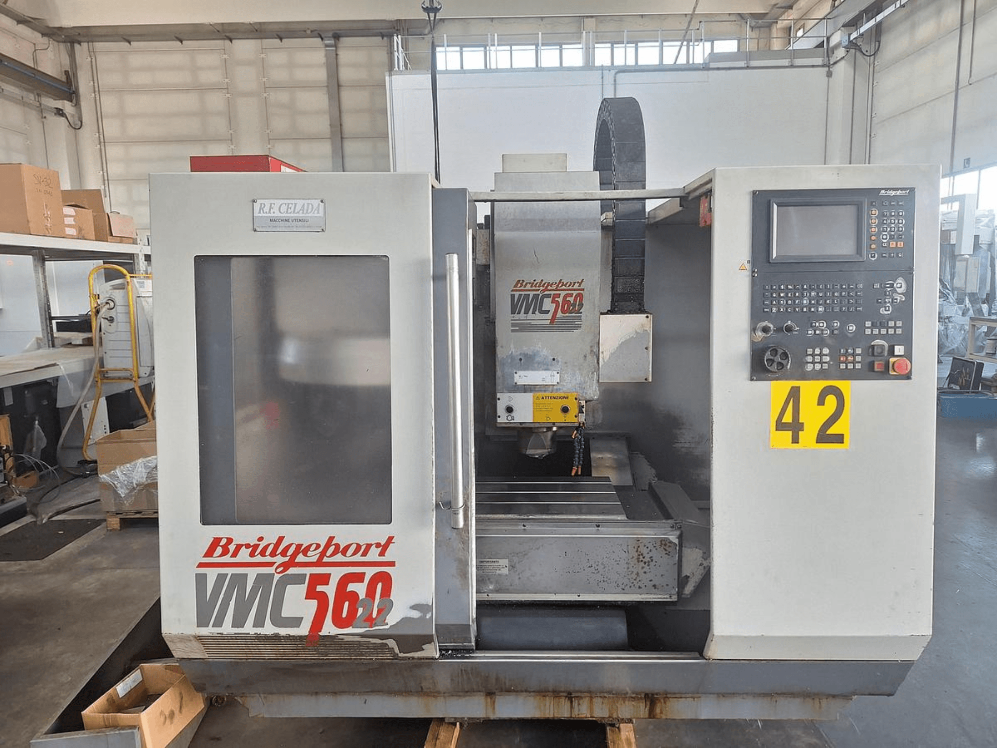 Bridgeport VMC 560/22 vertical machining center, front view, featuring control panel, tool holder, and work area.
