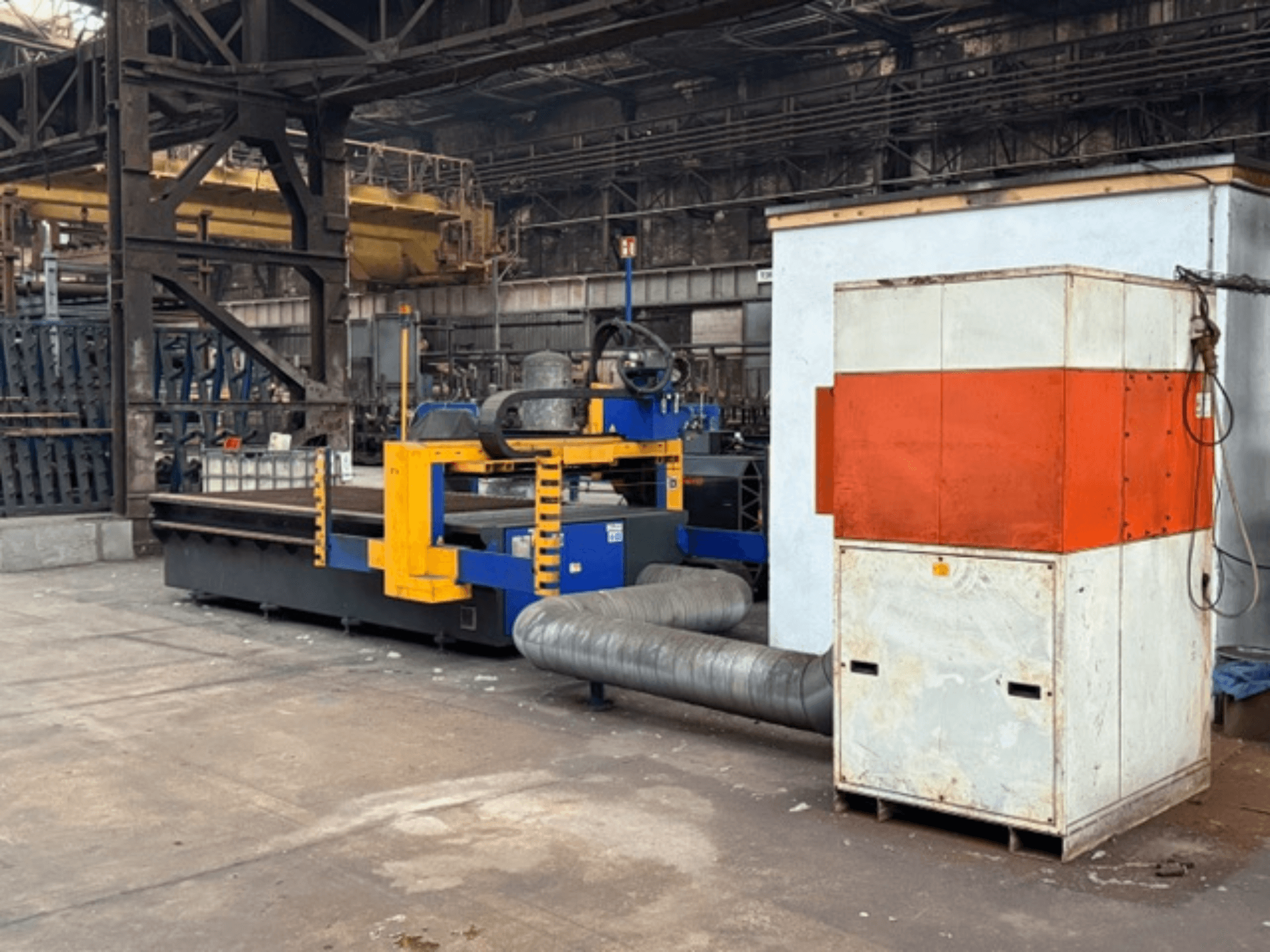 MicroStep 3001.15P/ME plasma cutting machine in a factory setting, side view, featuring yellow and blue components and an attached exhaust system.