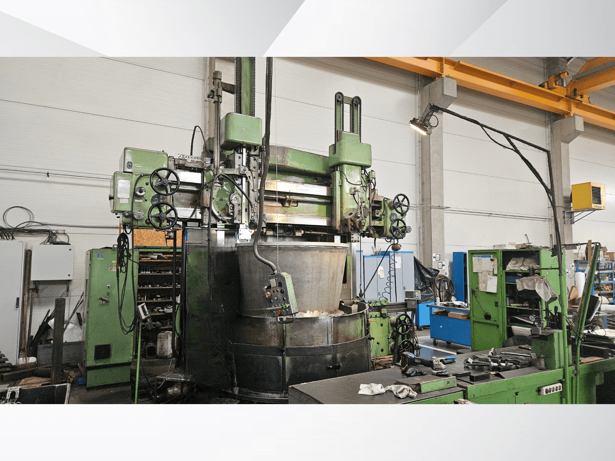 Vertical Turning Machine TOS SK 16 in a workshop; features green control panel, large rotating worktable, and levers.