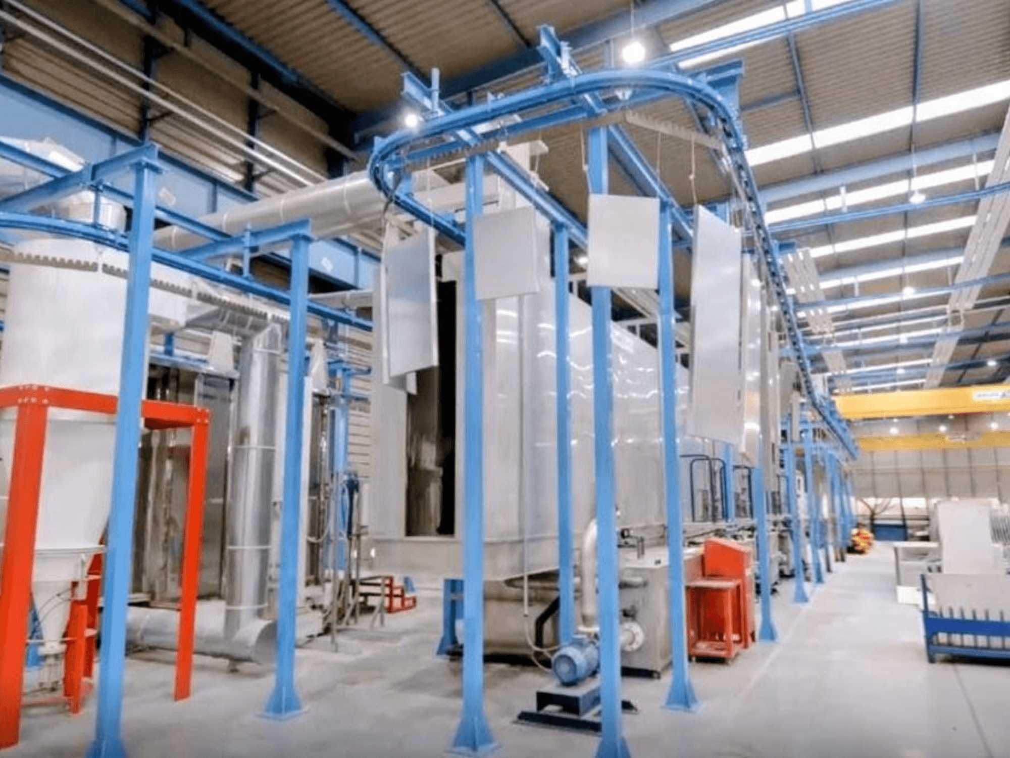 Front view of CABYCAL LPP sheet metal machine in a large industrial space, showcasing blue framework and machinery setup.