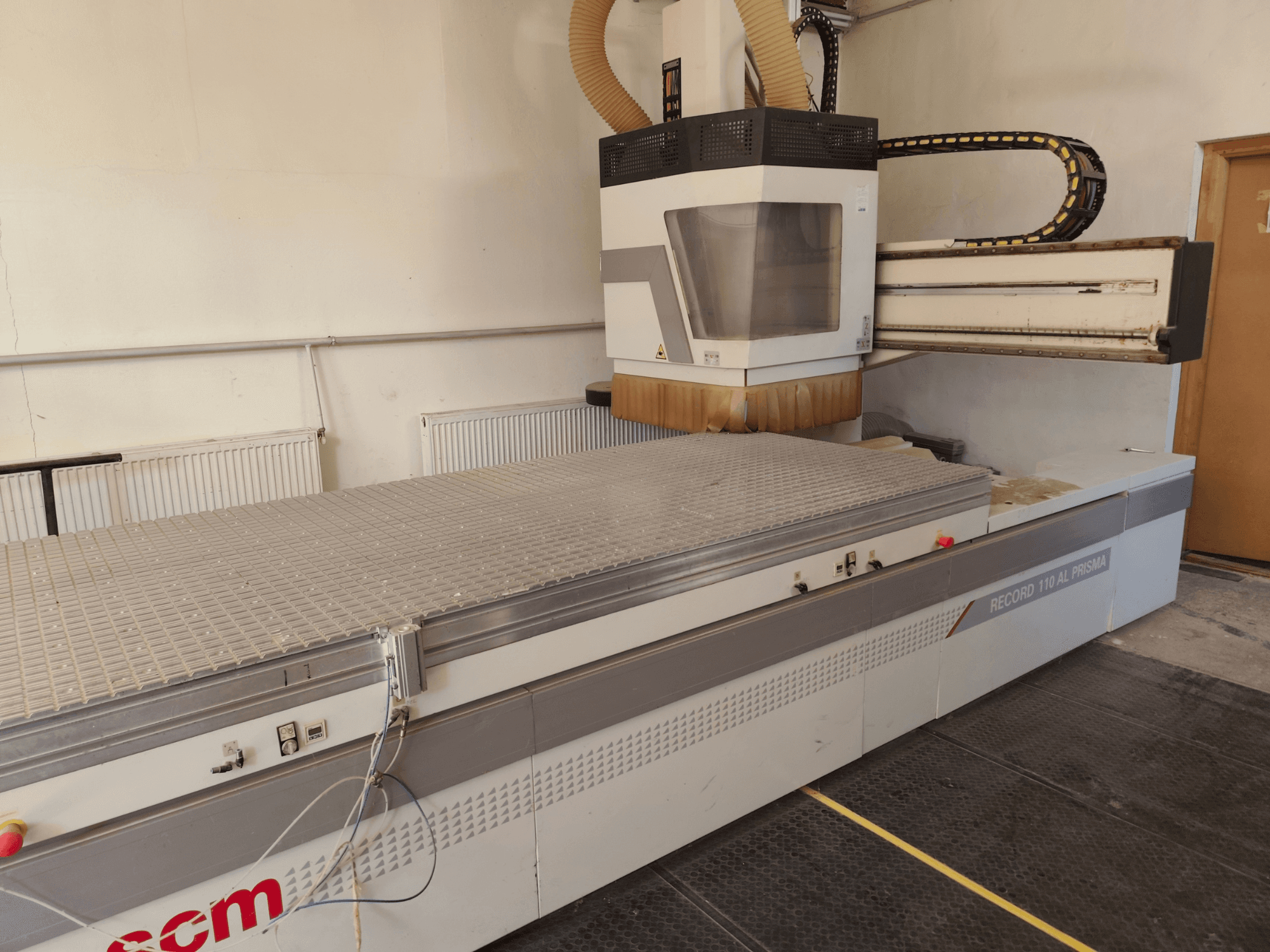 CNC wood machining centre SCM Record 110AL, side view showcasing large worktable and milling head.