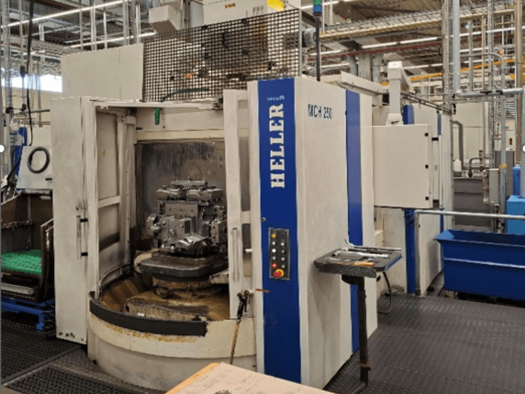 Horizontal machining center HELLER MCH 250, front view, with open doors revealing a workpiece, control panel visible.