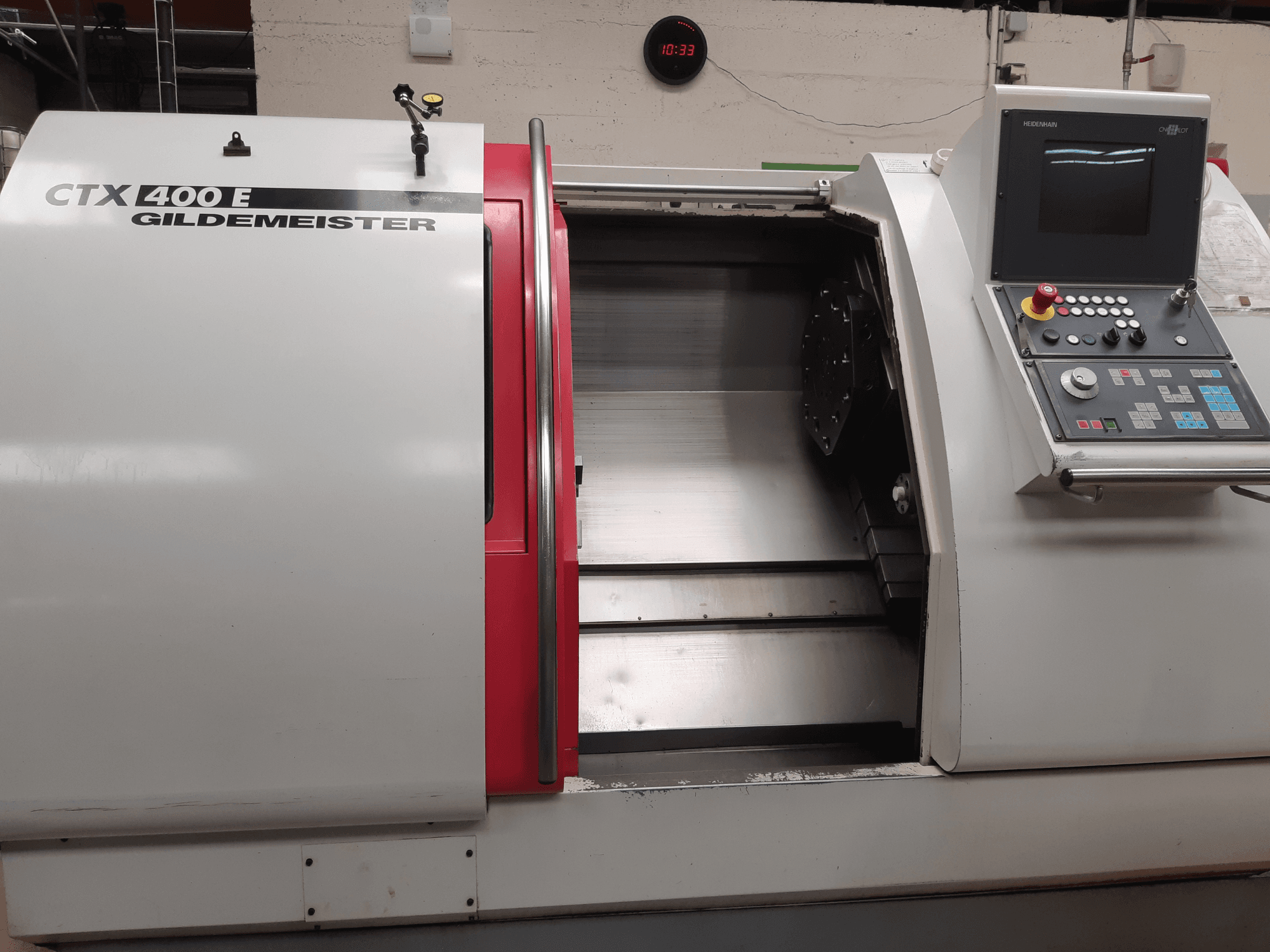 Gildemeister CTX 400 E horizontal turning machine at an angle, showing control panel and open front for tool access.
