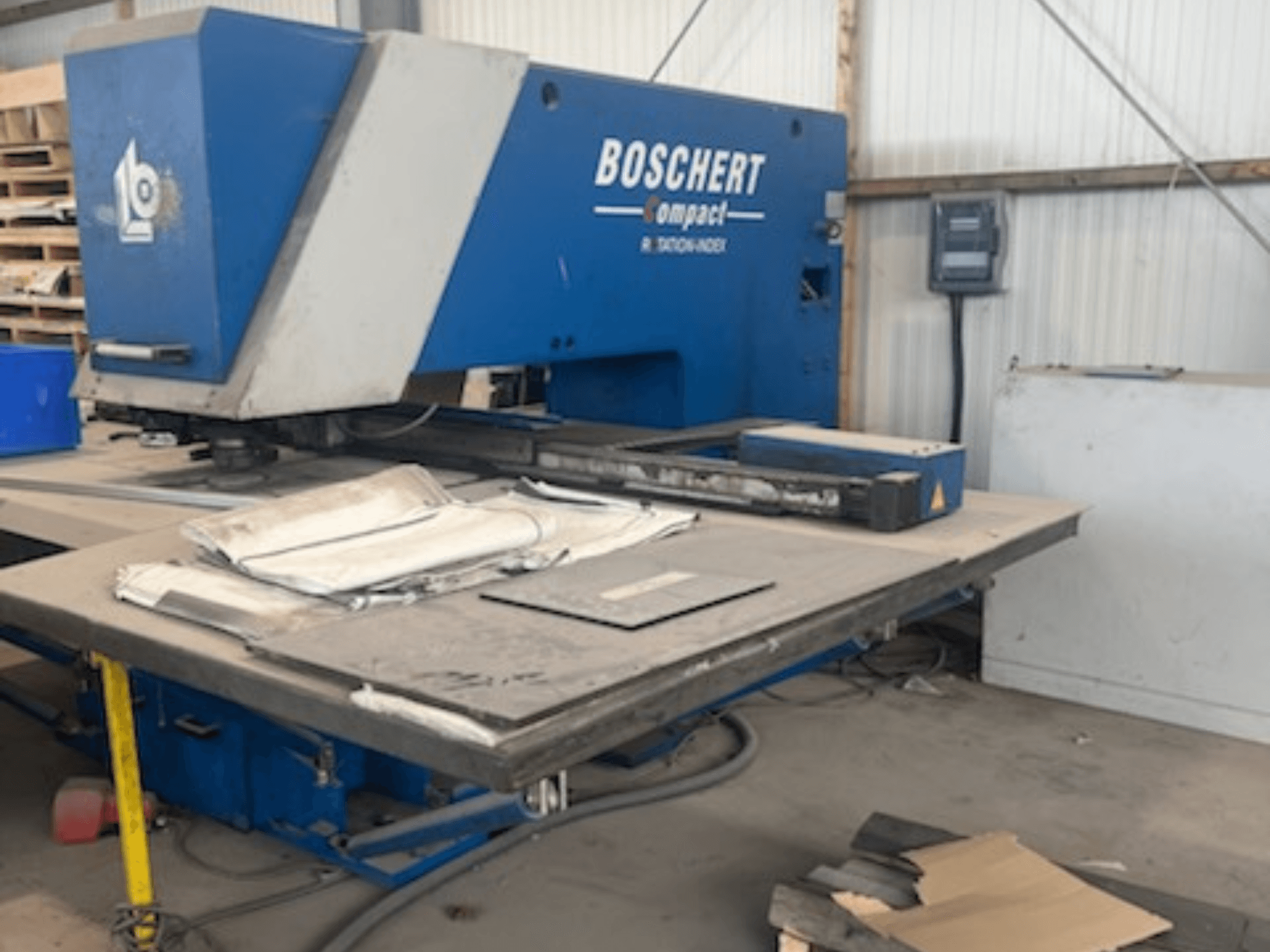BOSCHERT COMPACT 1000 CNC punching machine in a workshop, showing the front view with metal sheets on the table.