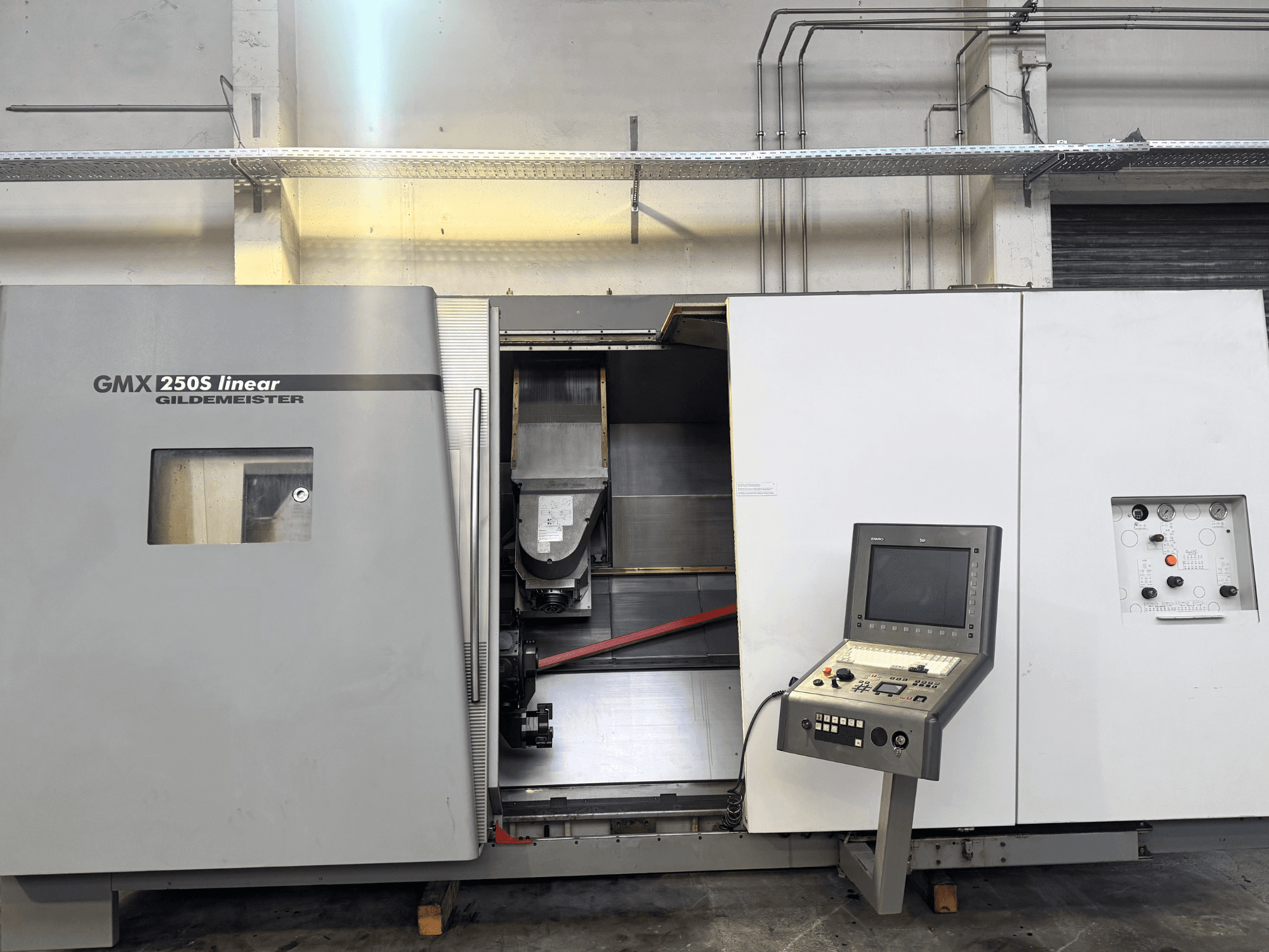 Gildemeister GMX 250S linear CNC machine, front view, showcasing control panel and open work area.