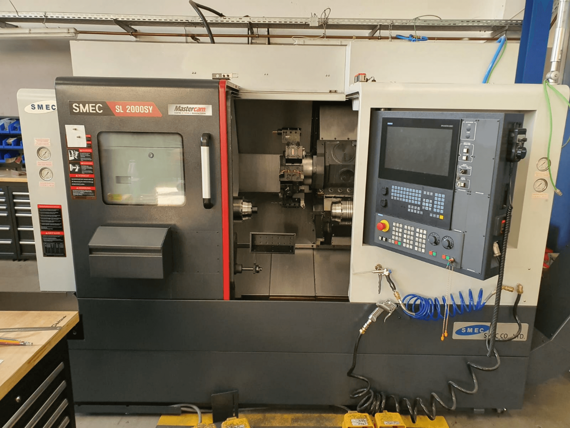 SMEC SL2000SY horizontal turning machine in front view, featuring control panel, display screen, and tool holder.