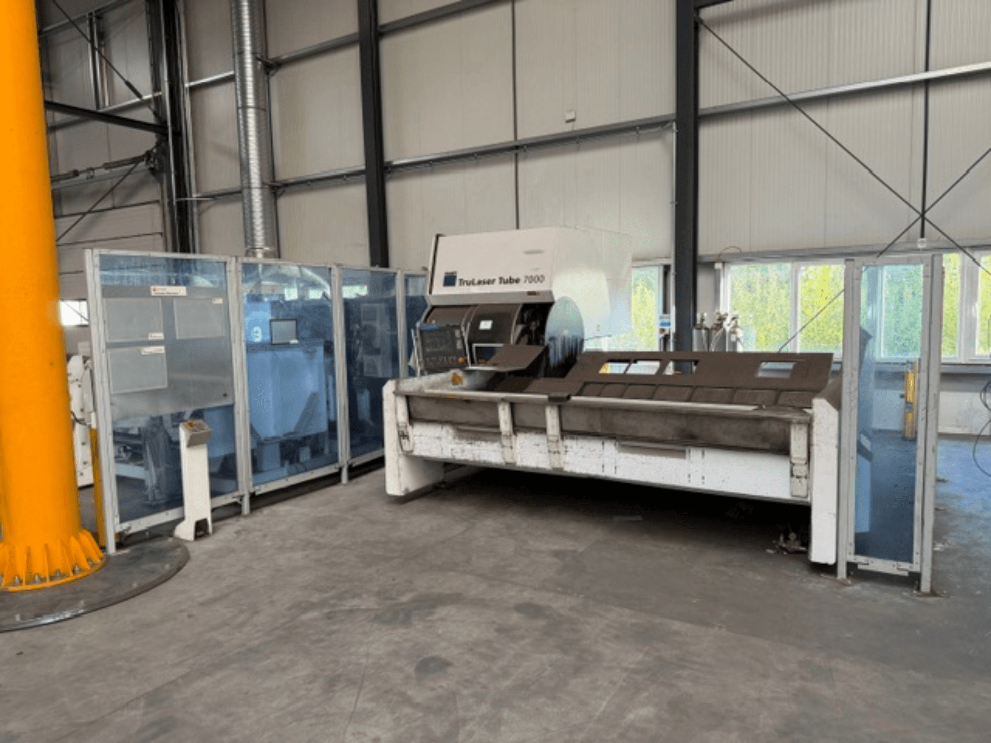 TruLaser Tube 7000 by TRUMPF, front view of a tube cutting machine in a well-lit industrial setting with operational controls visible.