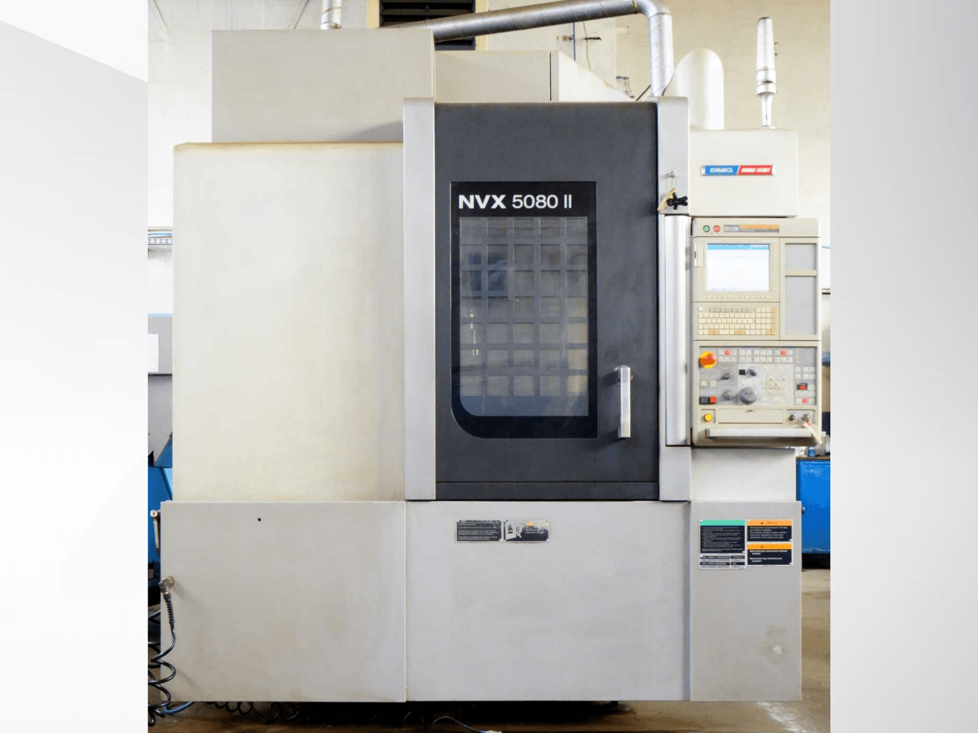 DMG Mori Seiki NVX 5080 II vertical machining centre, front view, featuring control panel and grid door design.