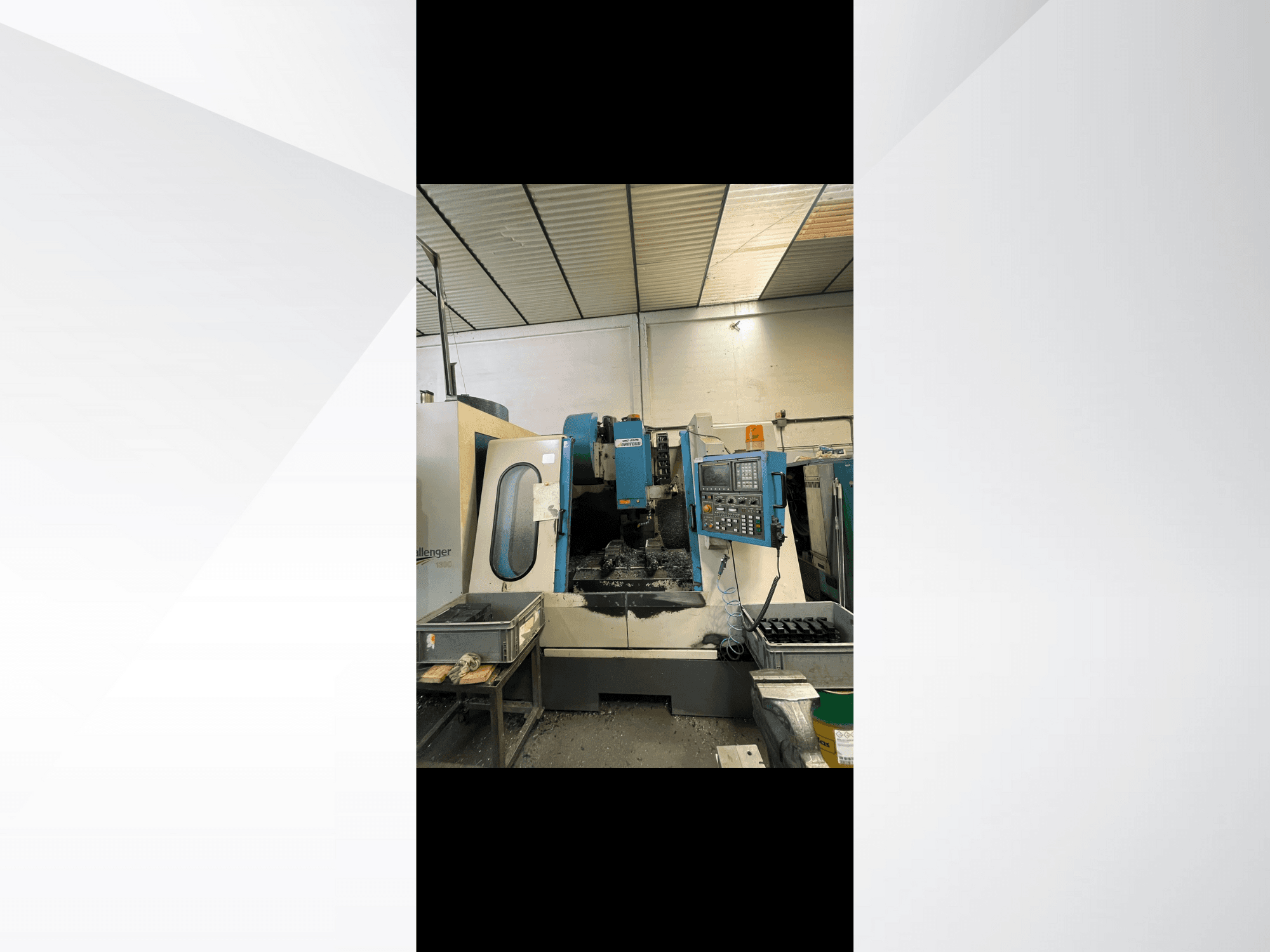 CNC machine, model Challenger 1500, side view showing control panel and workspace with metal shavings.
