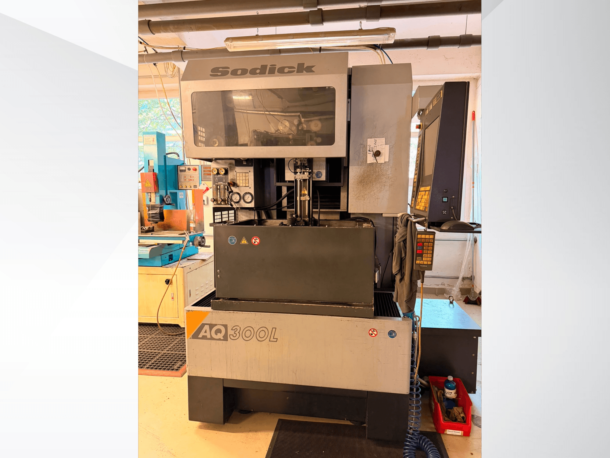 Sodick AQ300L Wire EDM machine, front view, featuring control panel, work area, and safety indicators visible.