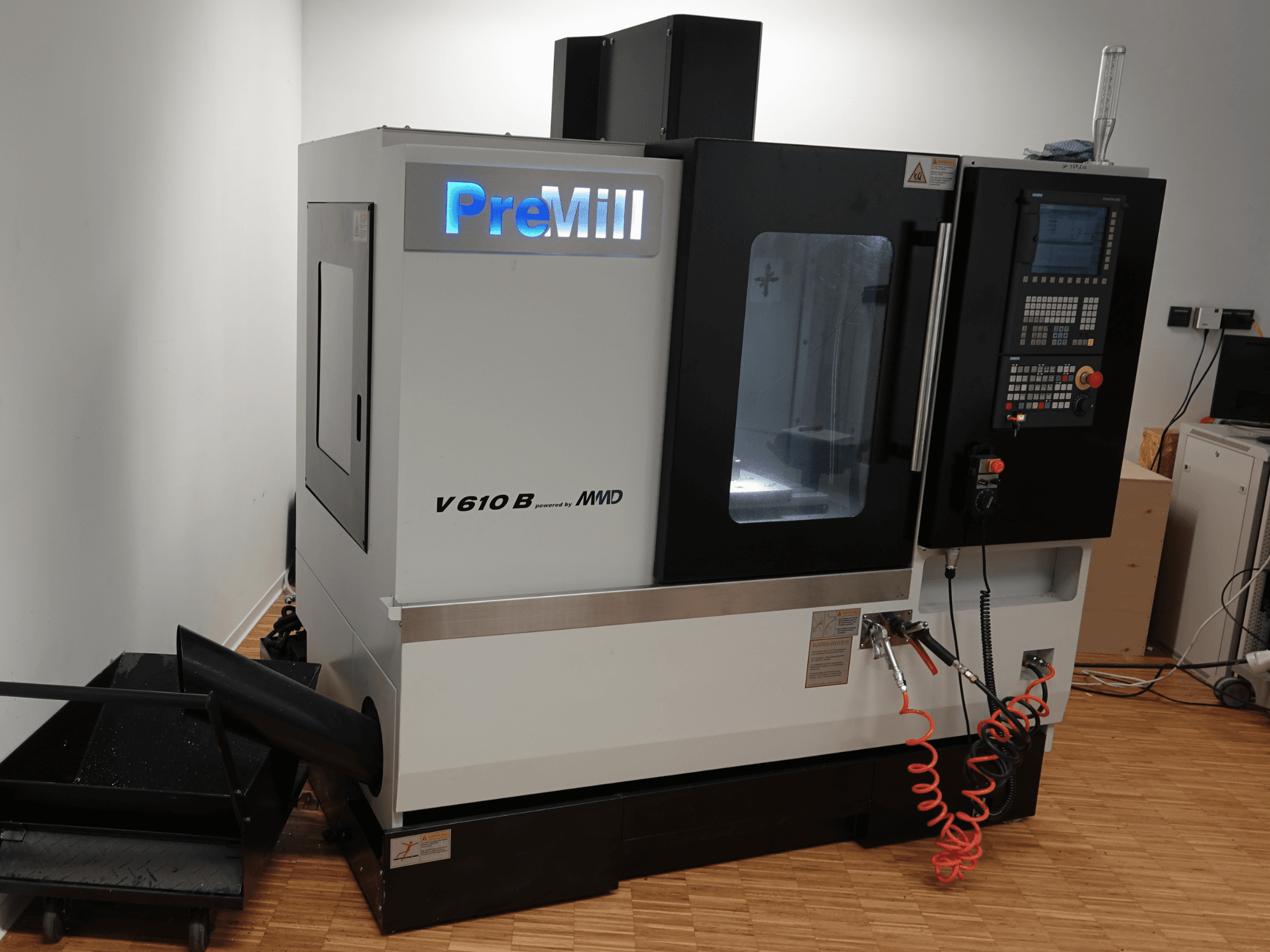 PreMill V 610 B vertical machining centre, front view, featuring control panel, coolant system, and attached air hoses.