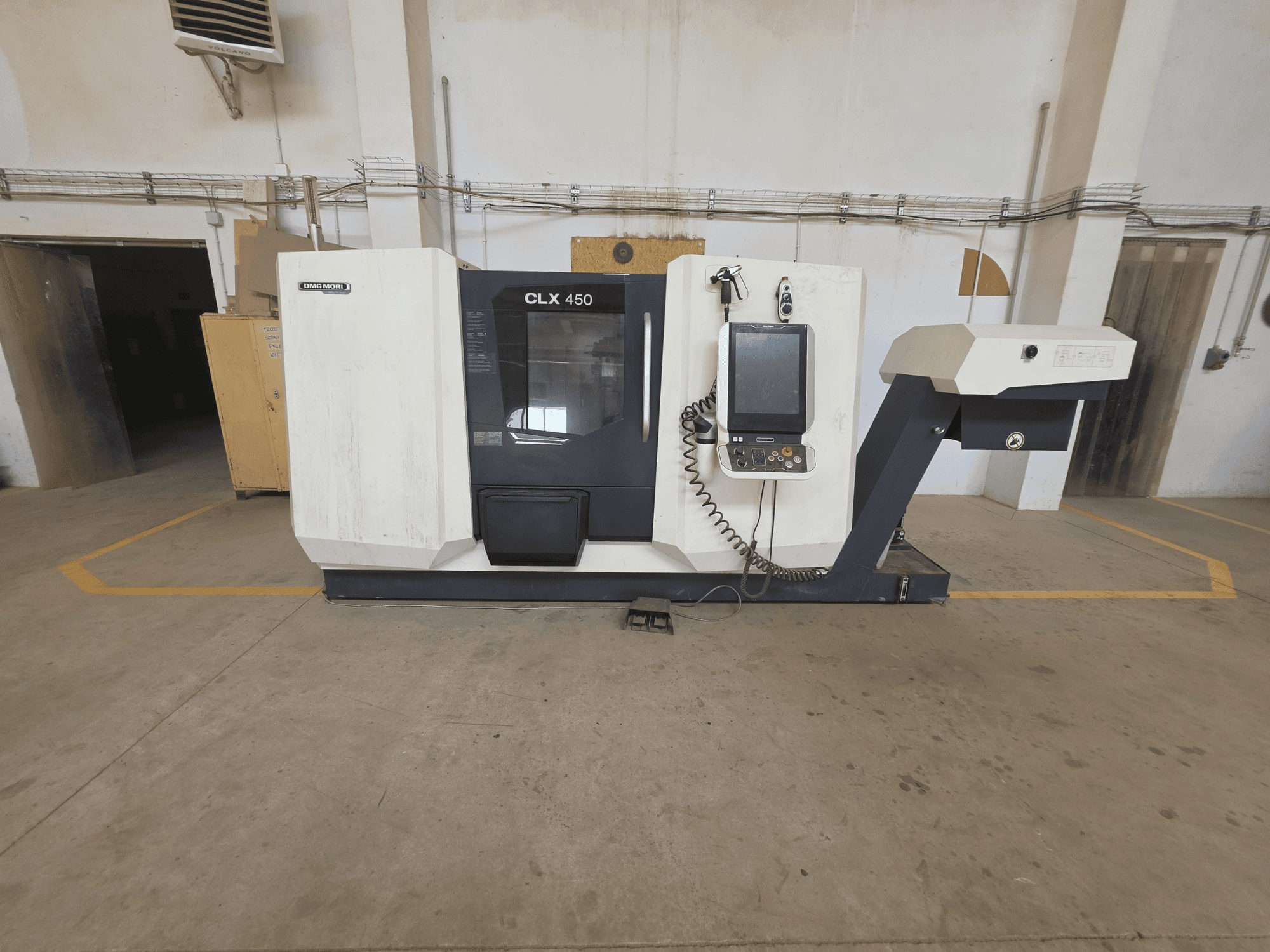 Horizontal view of DMG MORI CLX 450 V4 turning machine, featuring control panel, spindle area, and clean industrial setting.