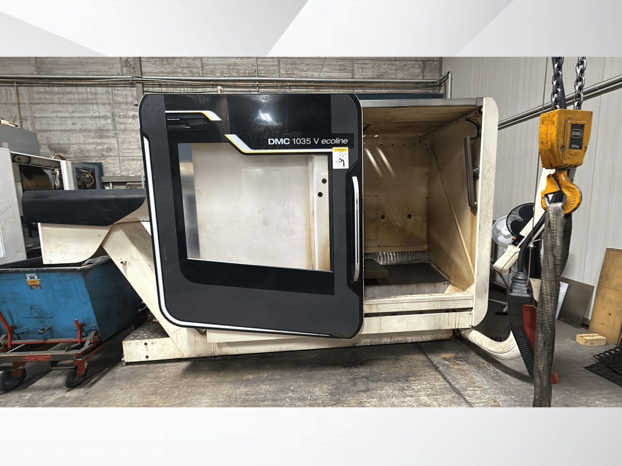 DMC 1035 V ecoline CNC machine, front view, features open door revealing an empty interior and control panel.