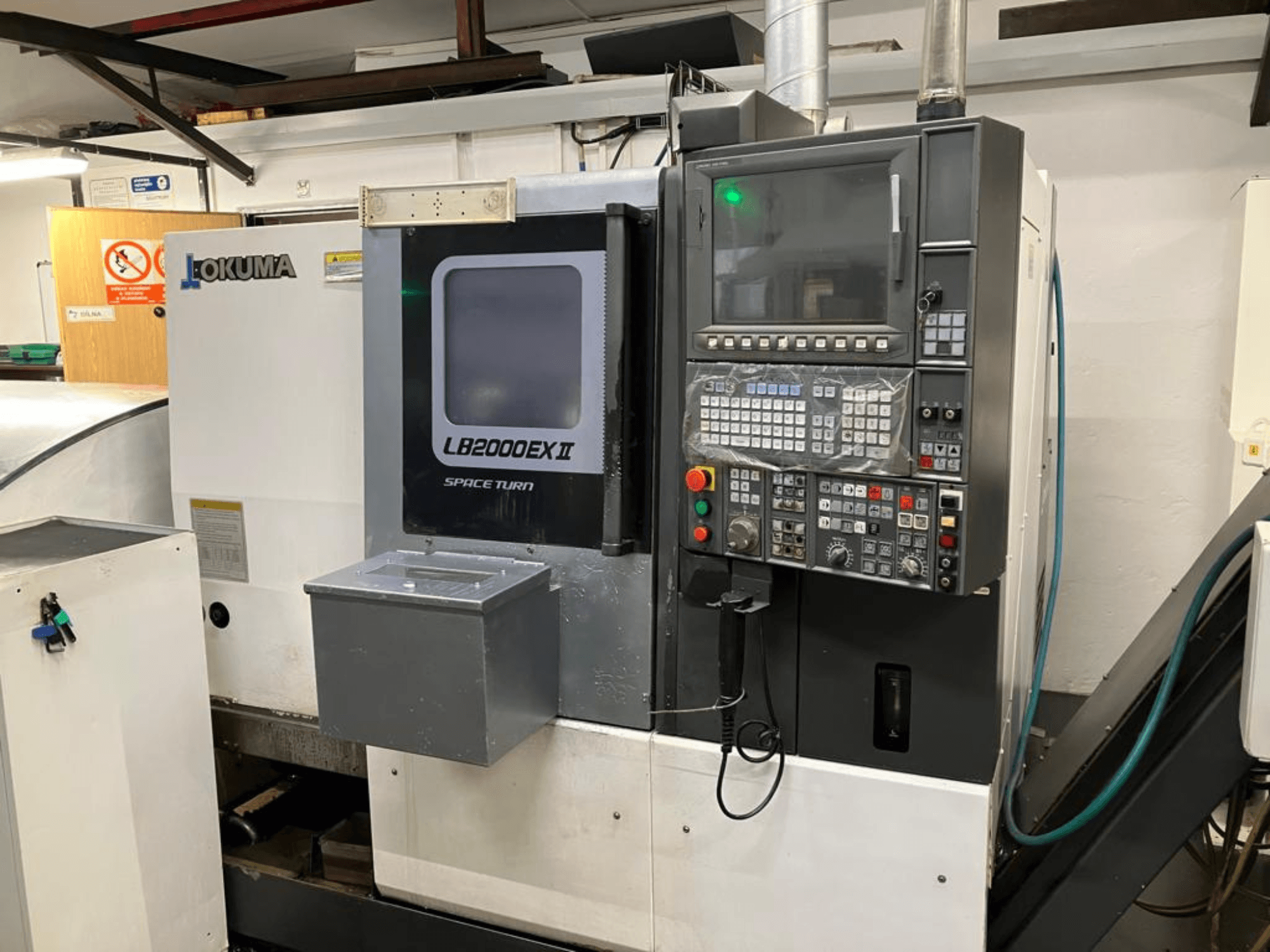 Okuma LB2000EXII MC horizontal turning machine, front view showcasing control panel and operational features.