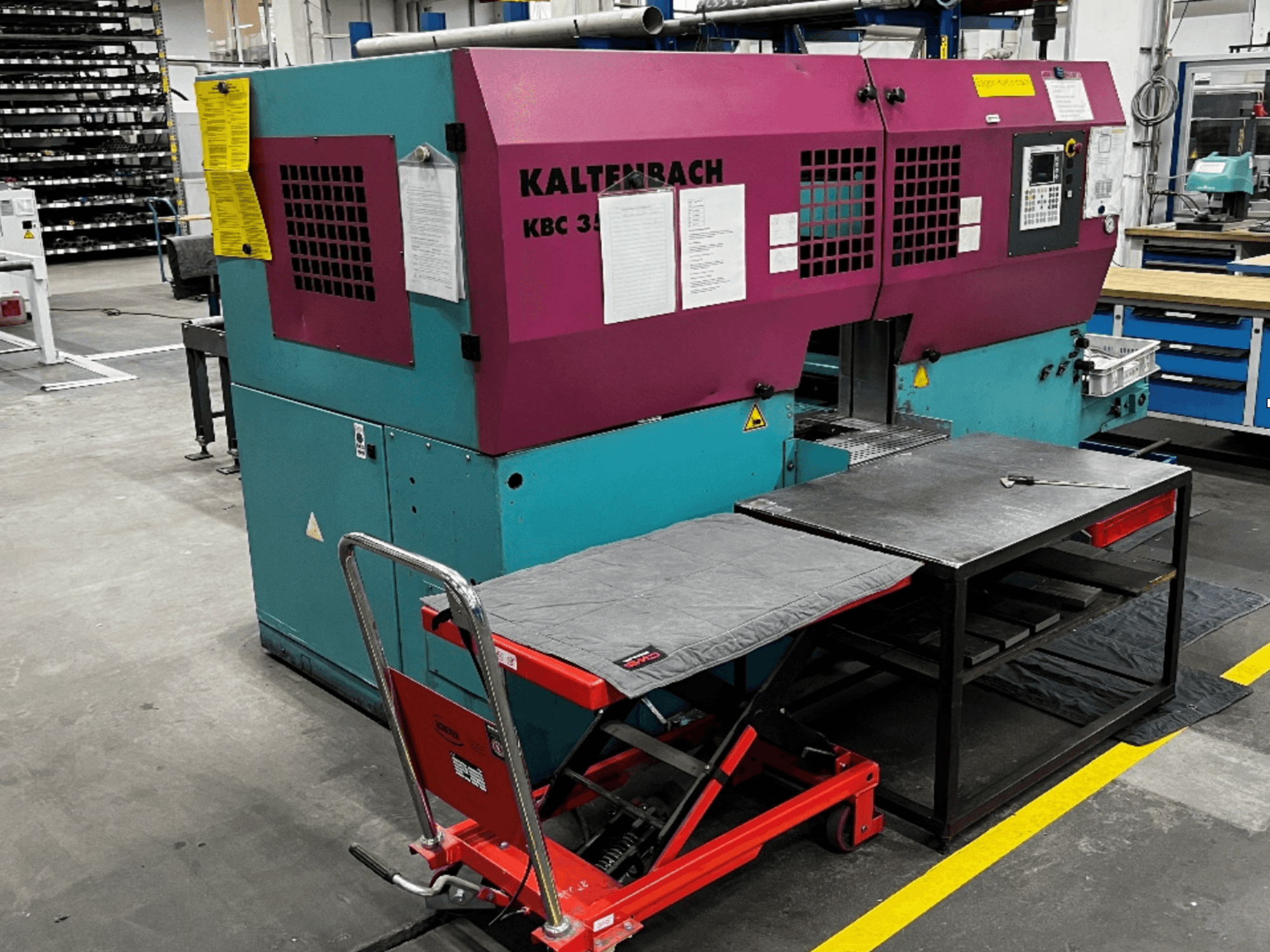 KALTENBACH KBC 350 NA Metal Band Saw in front view with a work table and red lifting cart in a workshop setting.