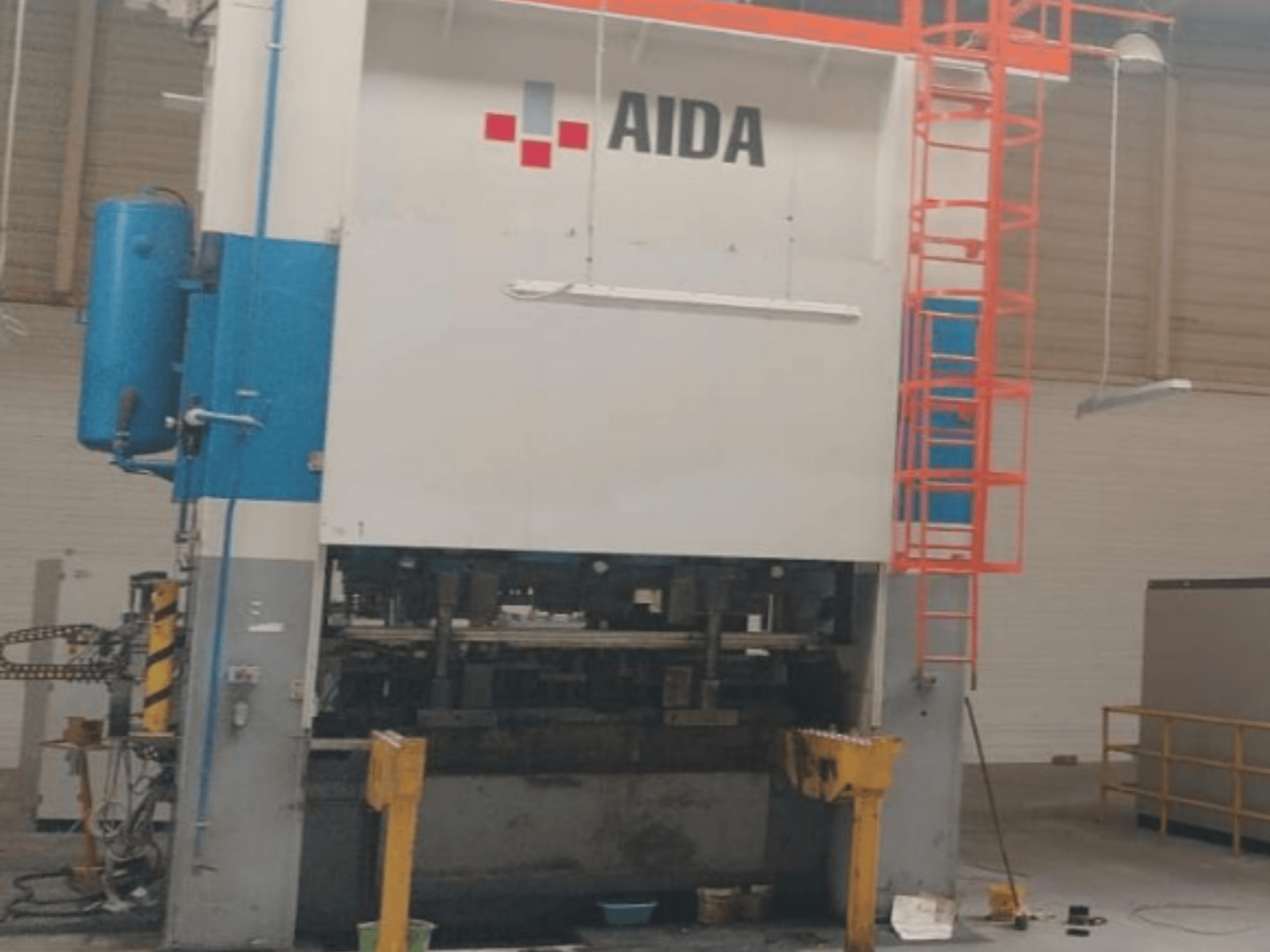 AIDA Mechanical Stamping Press 315/2MR/LD/TE3, front view, showcasing hydraulic components and safety ladder.