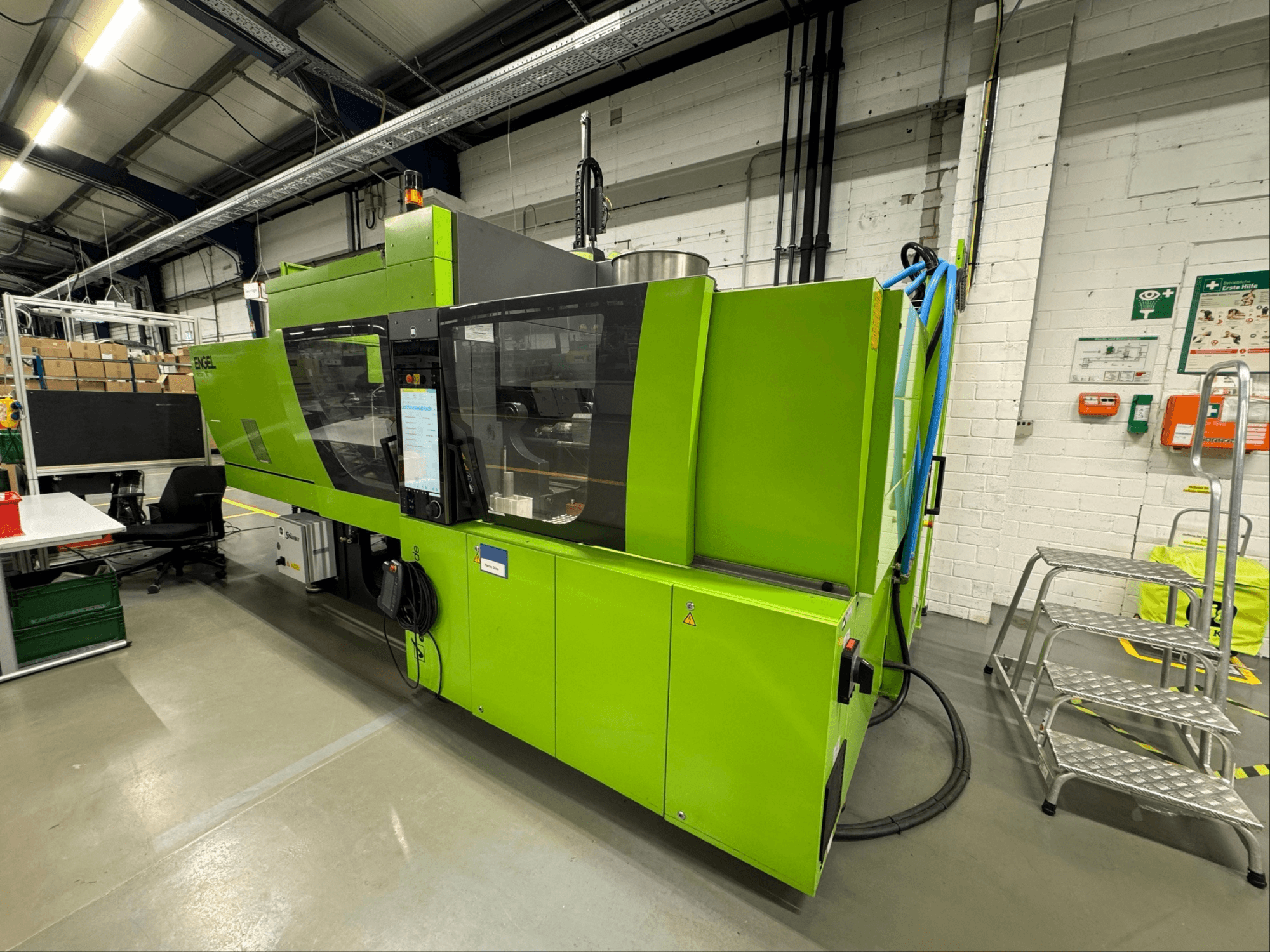 Engel Victory 200/90 tech hydraulic injection moulding machine in green, side view showcasing front control panel and surroundings.