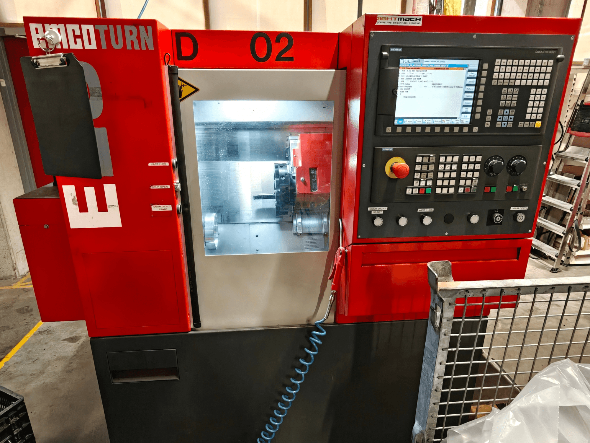 Front view of EMCO TURN E25 horizontal turning machine, showing control panel, display screen, and machining area.