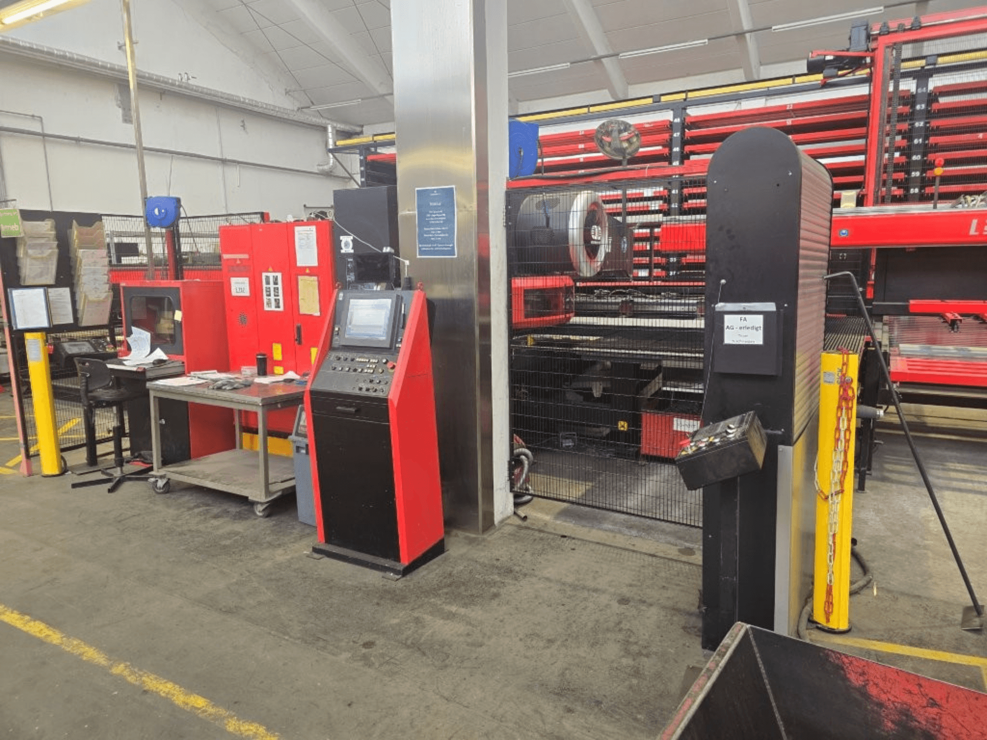 Front view of AMADA EMZ 3610 NT CNC Punching Machine, featuring operator controls and safety enclosure in a factory setting.