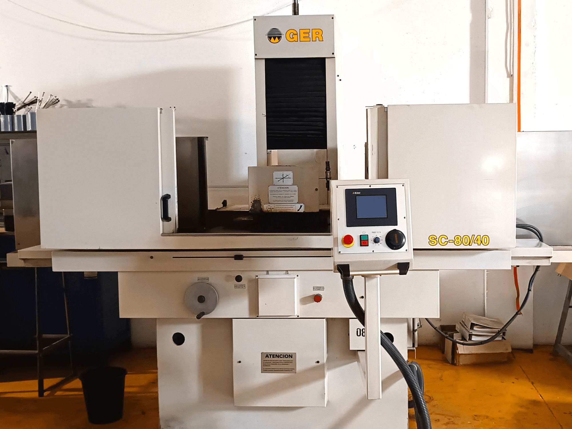 GER SC 80-40 surface grinding machine, front view, featuring control panel, grinding area, and safety labels.