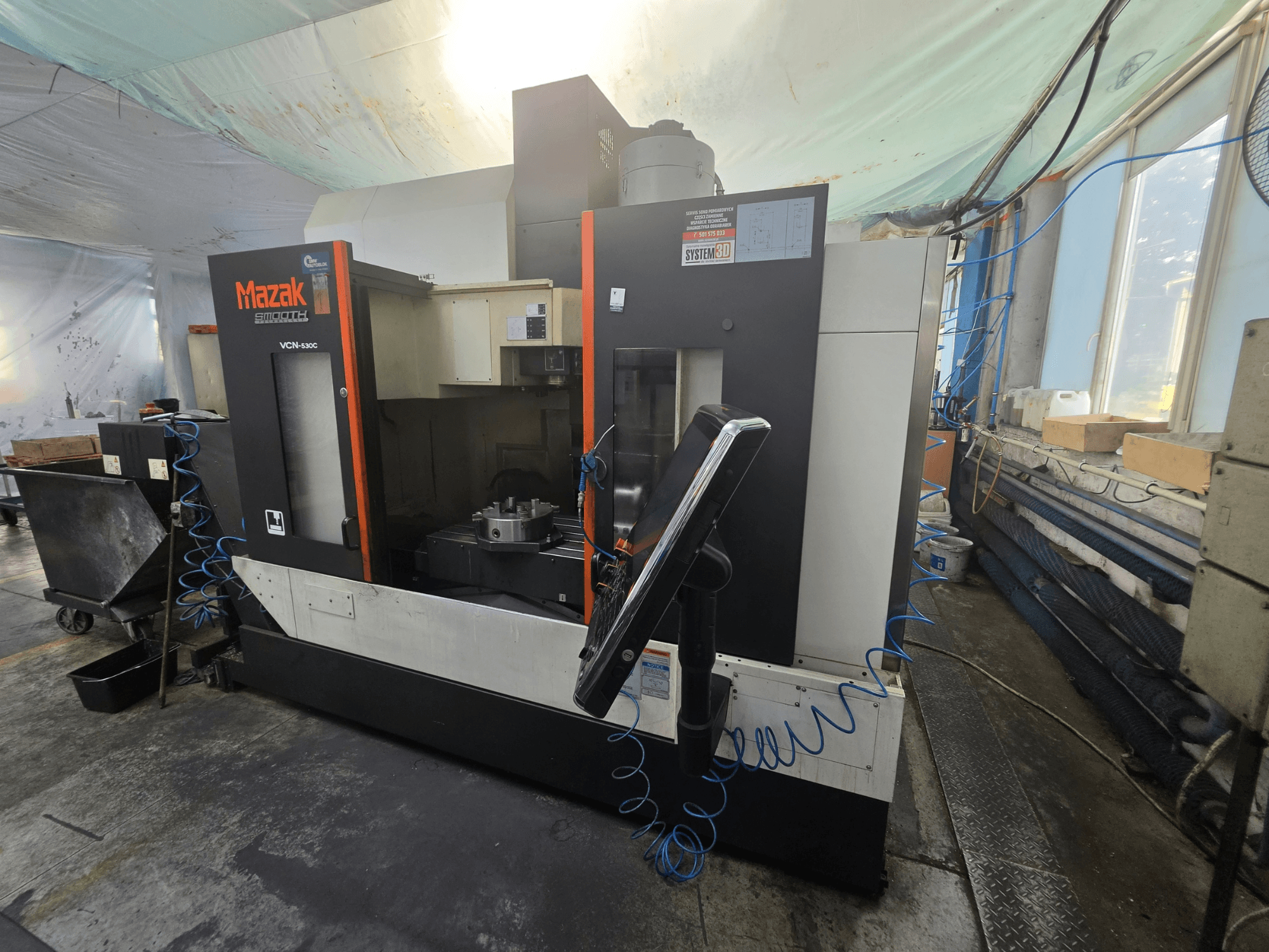 Mazak VCN-530C vertical machining center in front view, showcasing control panel, work area, and tool holder.