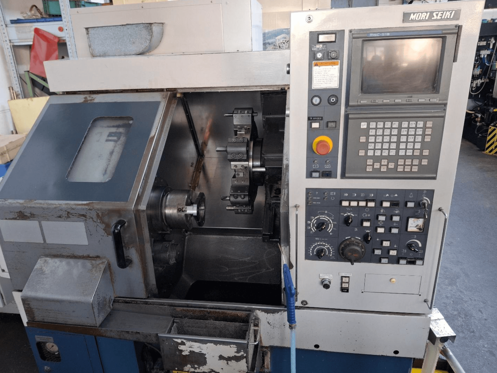 MORI SEIKI CL 15 horizontal turning machine, front view showcasing control panel and machining area.