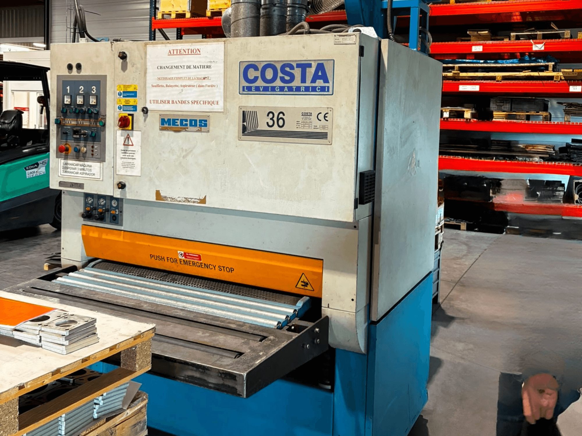 Costa M36 CCS 1150 deburring machine in side view, featuring control panel, emergency stop, and conveyor surface.